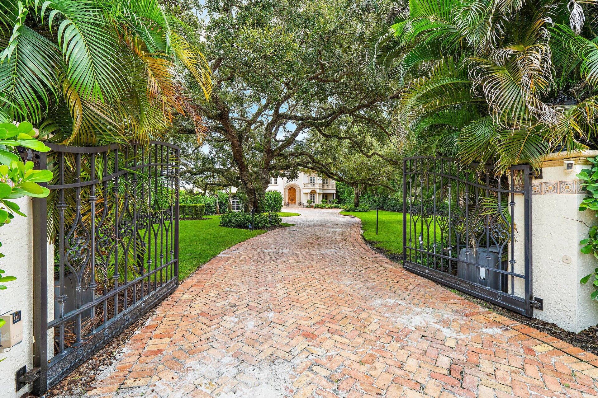 14898 PALMWOOD Road, Palm Beach Gardens, FL 33410 Privacy gates lead to the grand Intracoastal estate