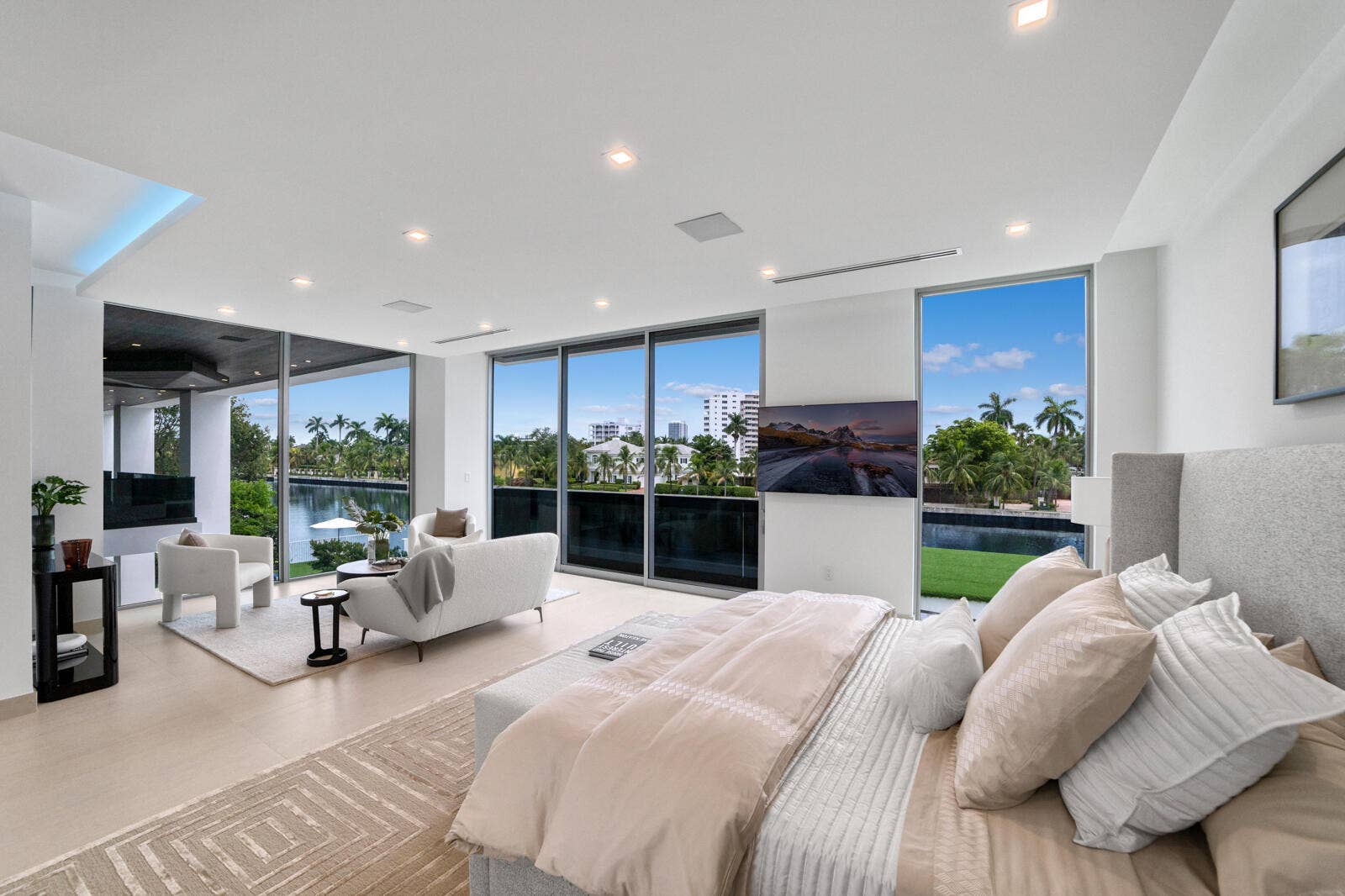 414 ROYAL PLAZA Drive, Fort Lauderdale, FL 33301 Private primary retreat with floor-to-ceiling glass framing sweeping canal and skyline views from the bedroom and adjoining sitting area.
