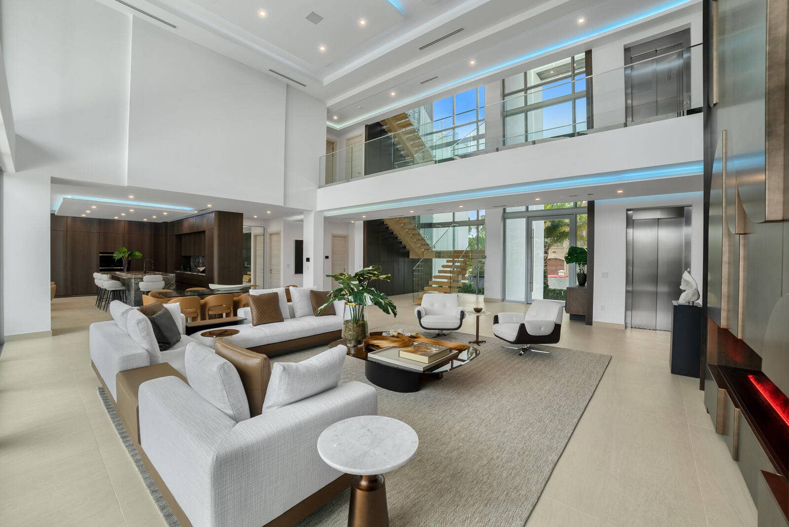 414 ROYAL PLAZA Drive, Fort Lauderdale, FL 33301 Grand interior perspective showcasing the floating wood staircase, frameless glass railings, commercial-grade elevator, and customizable architectural cove lighting.