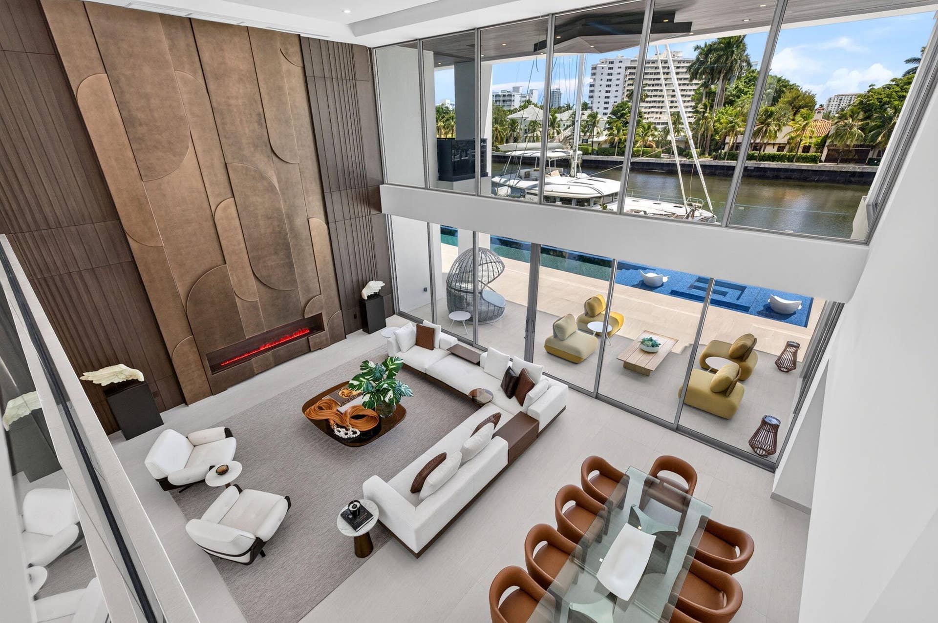 414 ROYAL PLAZA Drive, Fort Lauderdale, FL 33301 Second-floor view overlooking the dramatic two-story great room, infinity-edge pool, and waterfront beyond.