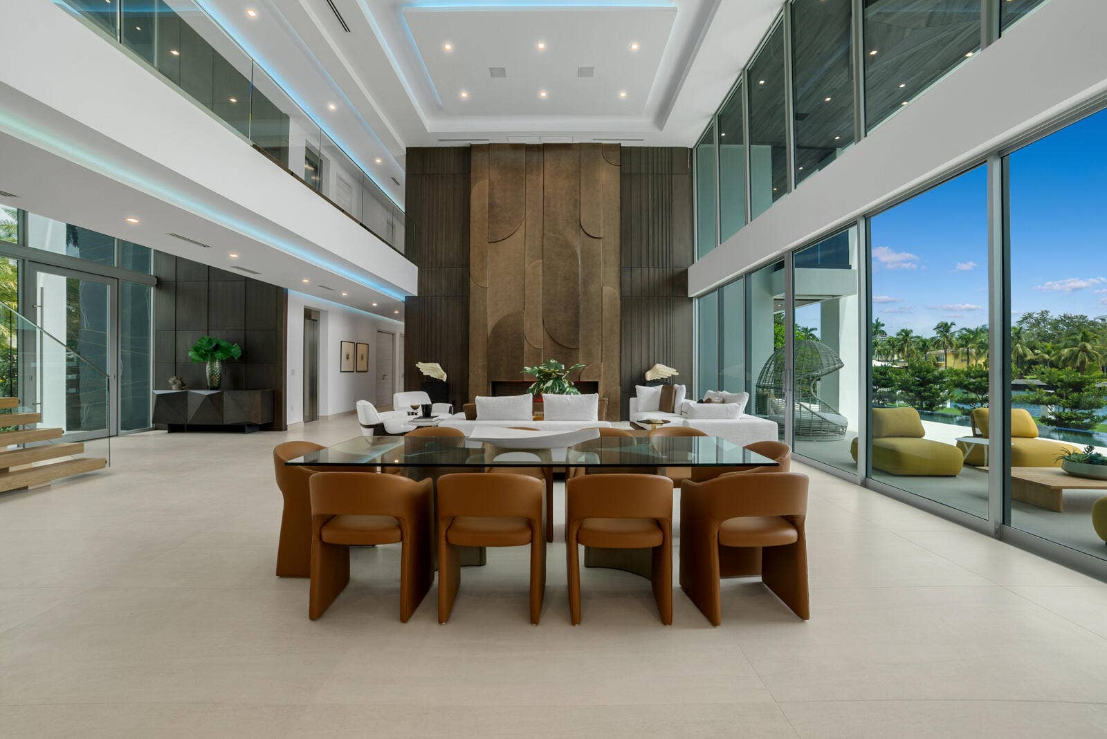 414 ROYAL PLAZA Drive, Fort Lauderdale, FL 33301 Elegant dining area surrounded by floor-to-ceiling glass, overlooking the waterfront and anchored by the magnificent three-level paneled fireplace wall.