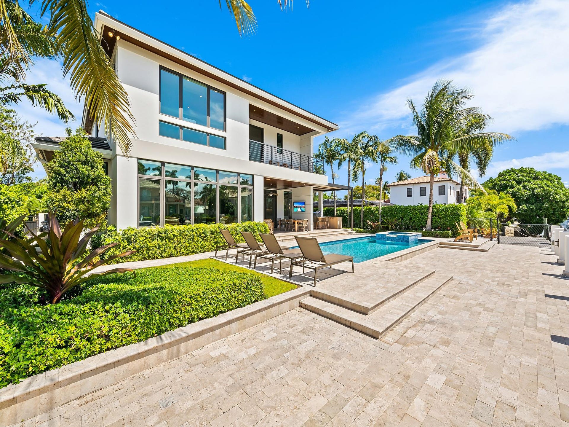 A backyard oasis complete with a sparkling pool/spa and a stylish summer kitchen
