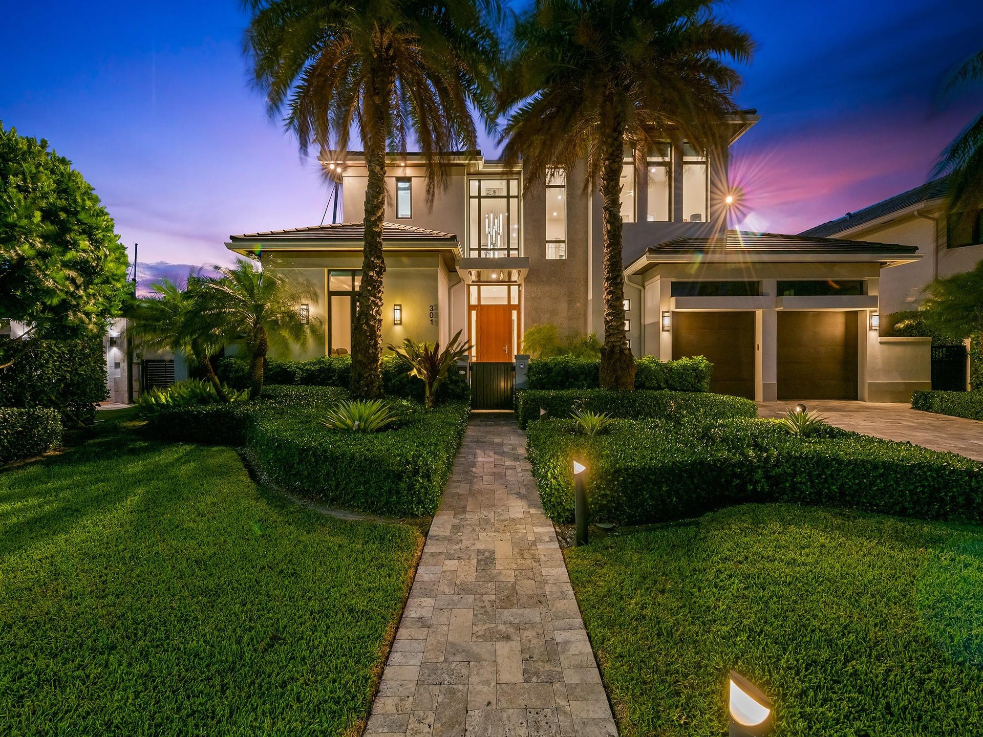301 NE 23RD Avenue, Fort Lauderdale, FL 33305 The twilight hour illuminates this home creating a serene and captivating nighttime ambiance.