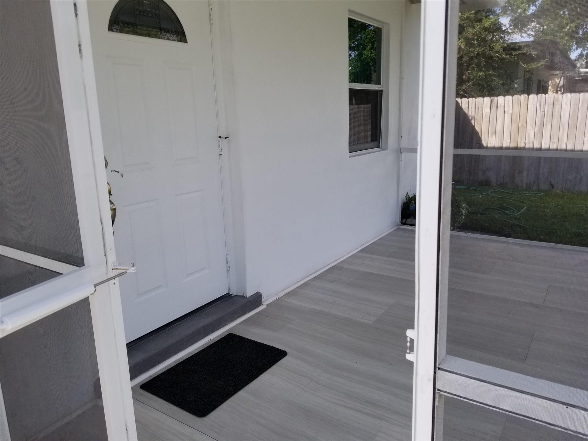 Screened porch with wood-look tile flooring