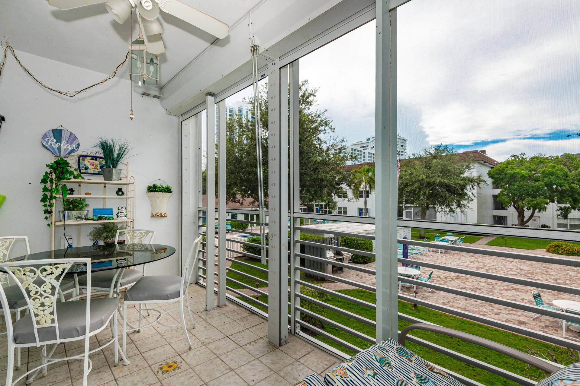 Screened porch with electric roll down shutters!
