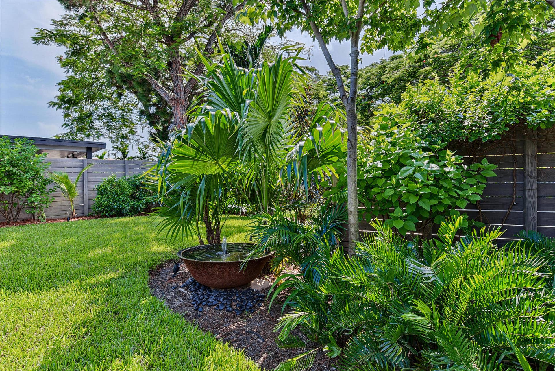 4850 NE 5TH Avenue, Oakland Park, FL 33334 Mature Florida native landscaping, tranquill water feature and still room for the pets and the children to paly.