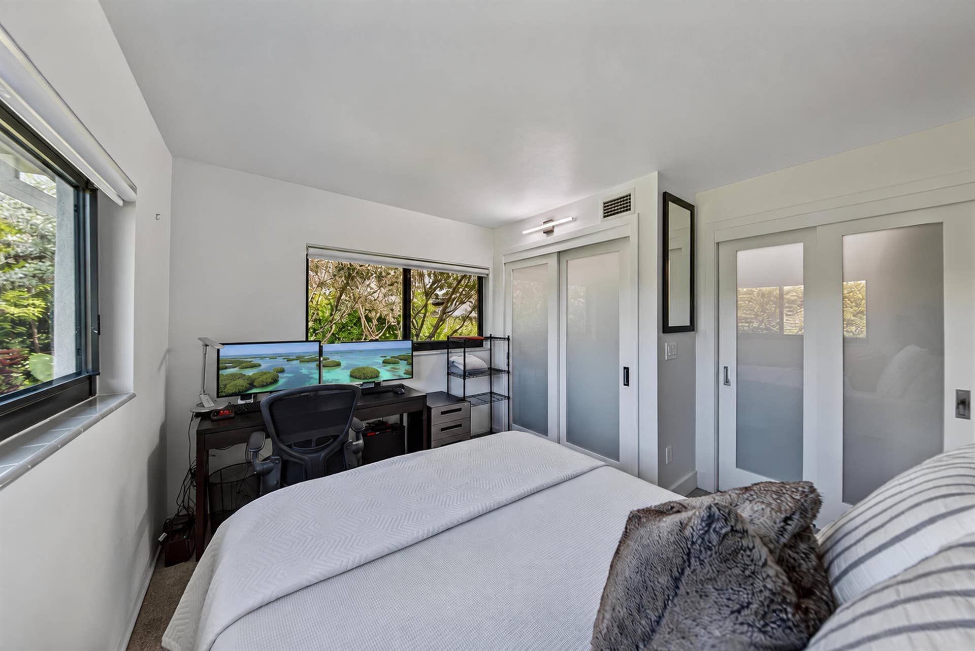 4850 NE 5TH Avenue, Oakland Park, FL 33334 Recessed lighting, large windows, sliding closet doors with frosted glass panels, and built-in overhead lighting