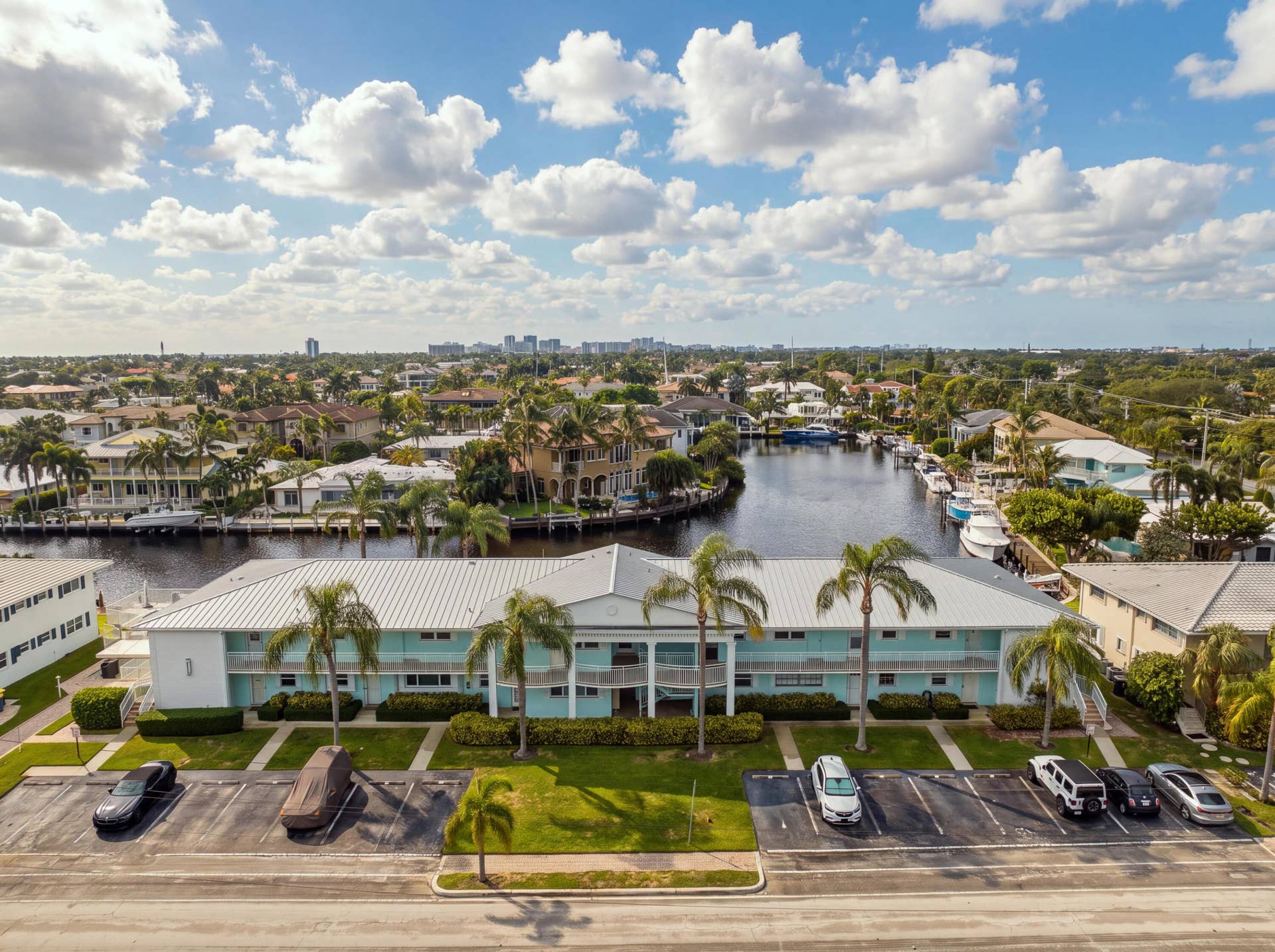 2330 NE 36th Street, #11, Lighthouse Point, FL 33064 Two-story building with a light blue and white exterior, featuring a metal roof and multiple balconies
