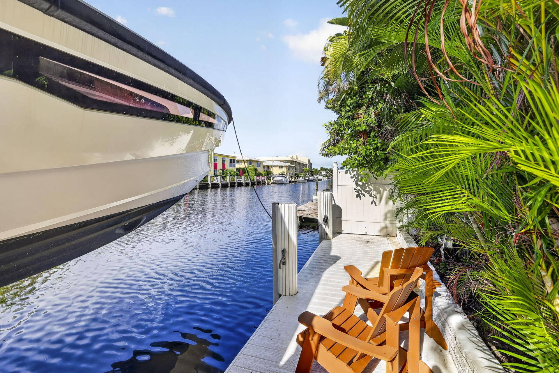Waterfront property with private dock access and mature tropical landscaping