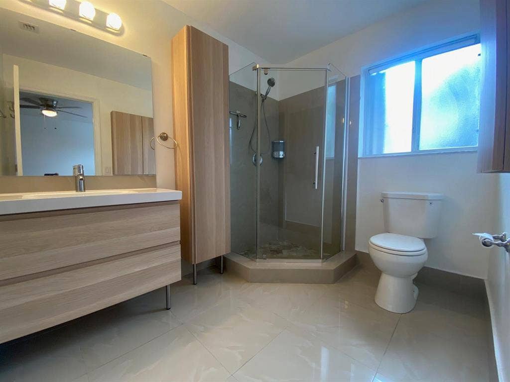 791 NW 42ND Place, Deerfield Beach, Deerfield Beach, FL 33064 Large Primary en suite bathroom w/ modern vanity w/ glass-enclosed shower, tiled flooring, and a privacy window