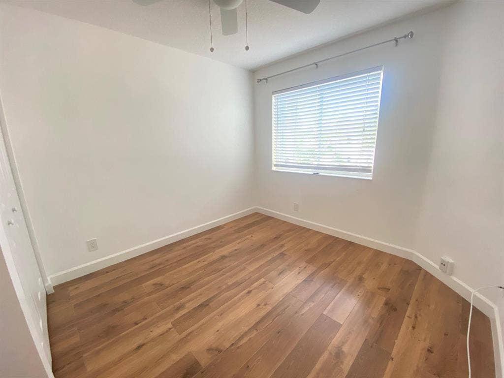 791 NW 42ND Place, Deerfield Beach, Deerfield Beach, FL 33064 2nd bedroom w/ wood-finish flooring, ceiling fan, and window with blinds