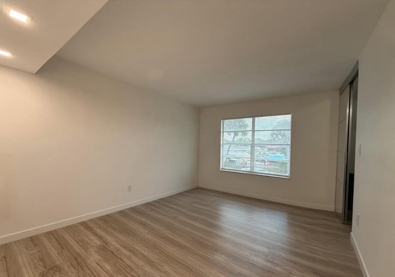 809 W Oakland Park Boulevard, #K4, Wilton Manors, FL 33311 Recessed ceiling lighting, wood-finish flooring, and a window with horizontal muntins