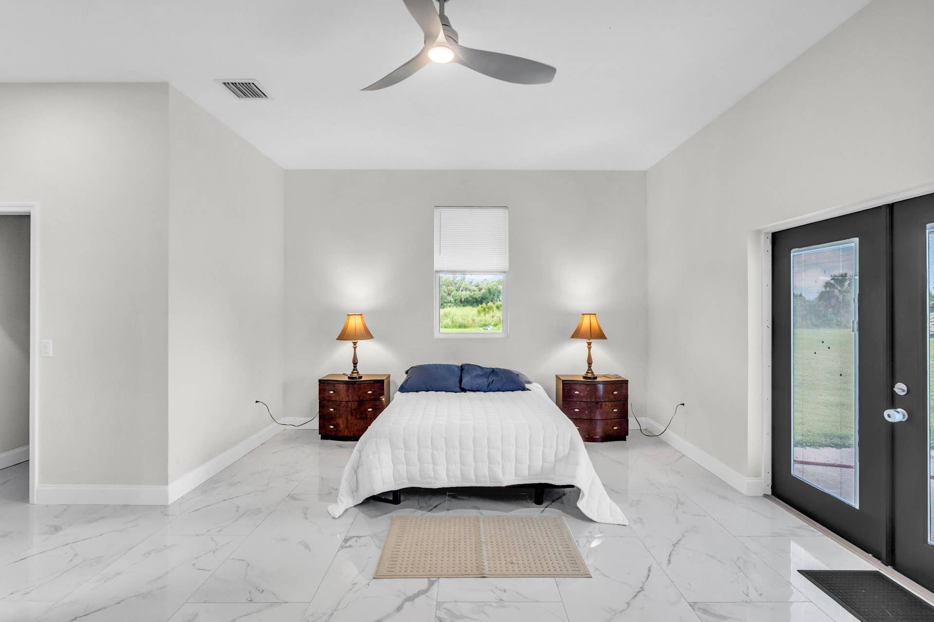 Primary suite with ceiling fan and French doors