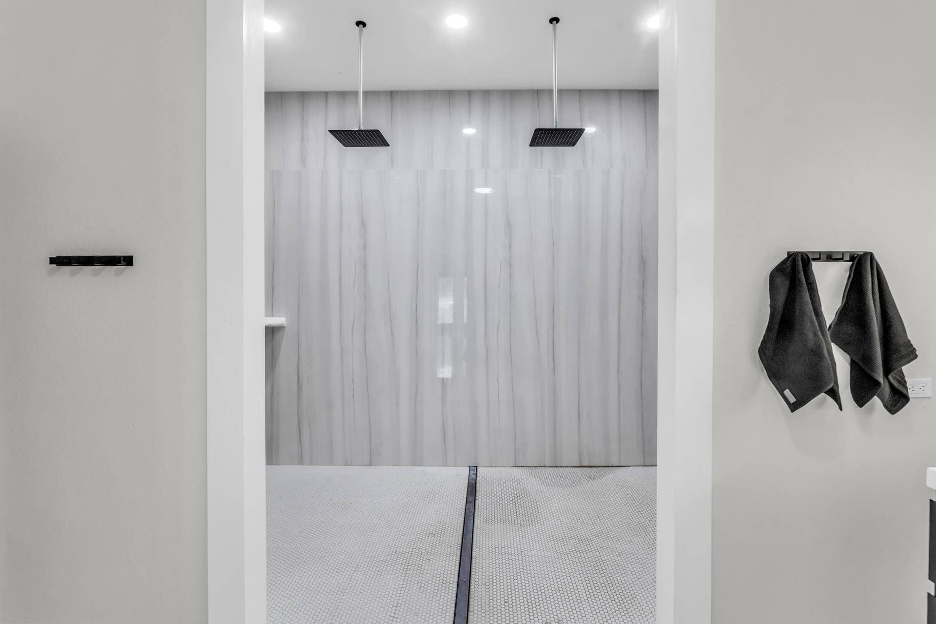 Oversized walk-in shower with dual rain showerheads