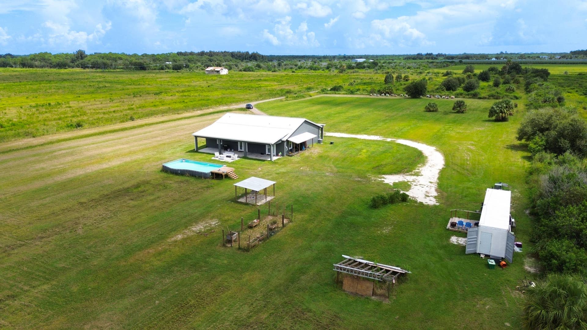 Aerial of the homesite with pool, guest unit and curved drive