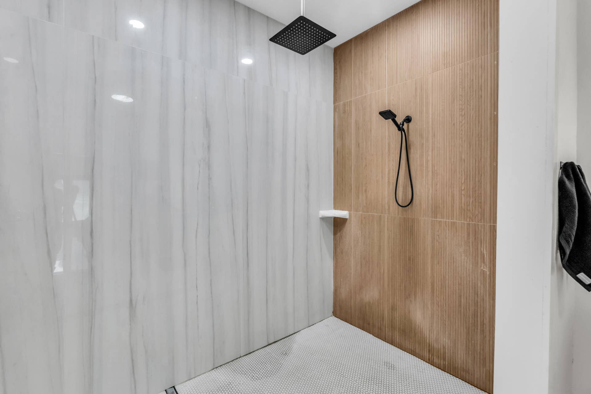 Walk-in shower with wood-look tile accent wall