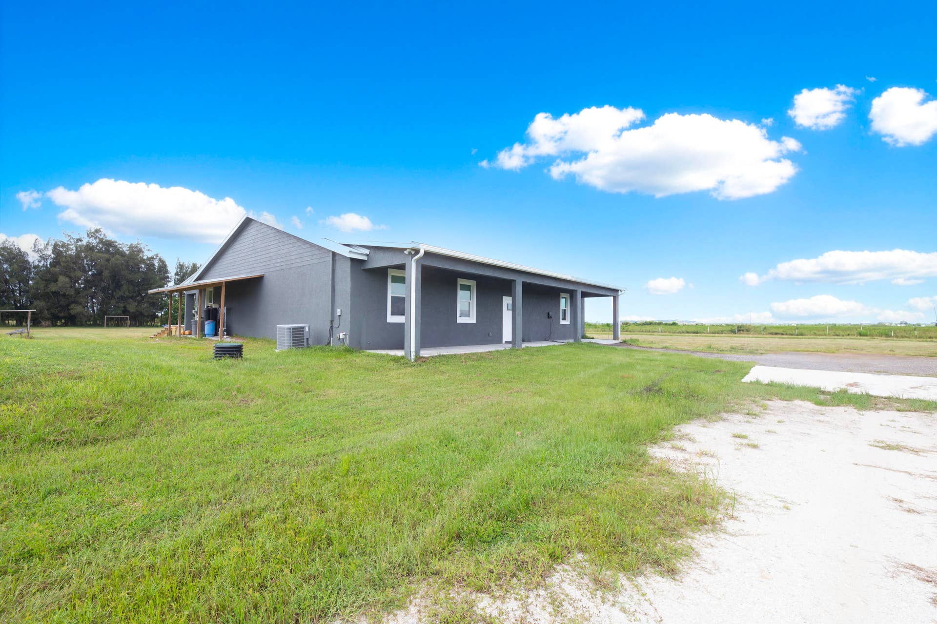 Side view of the home set back on open land