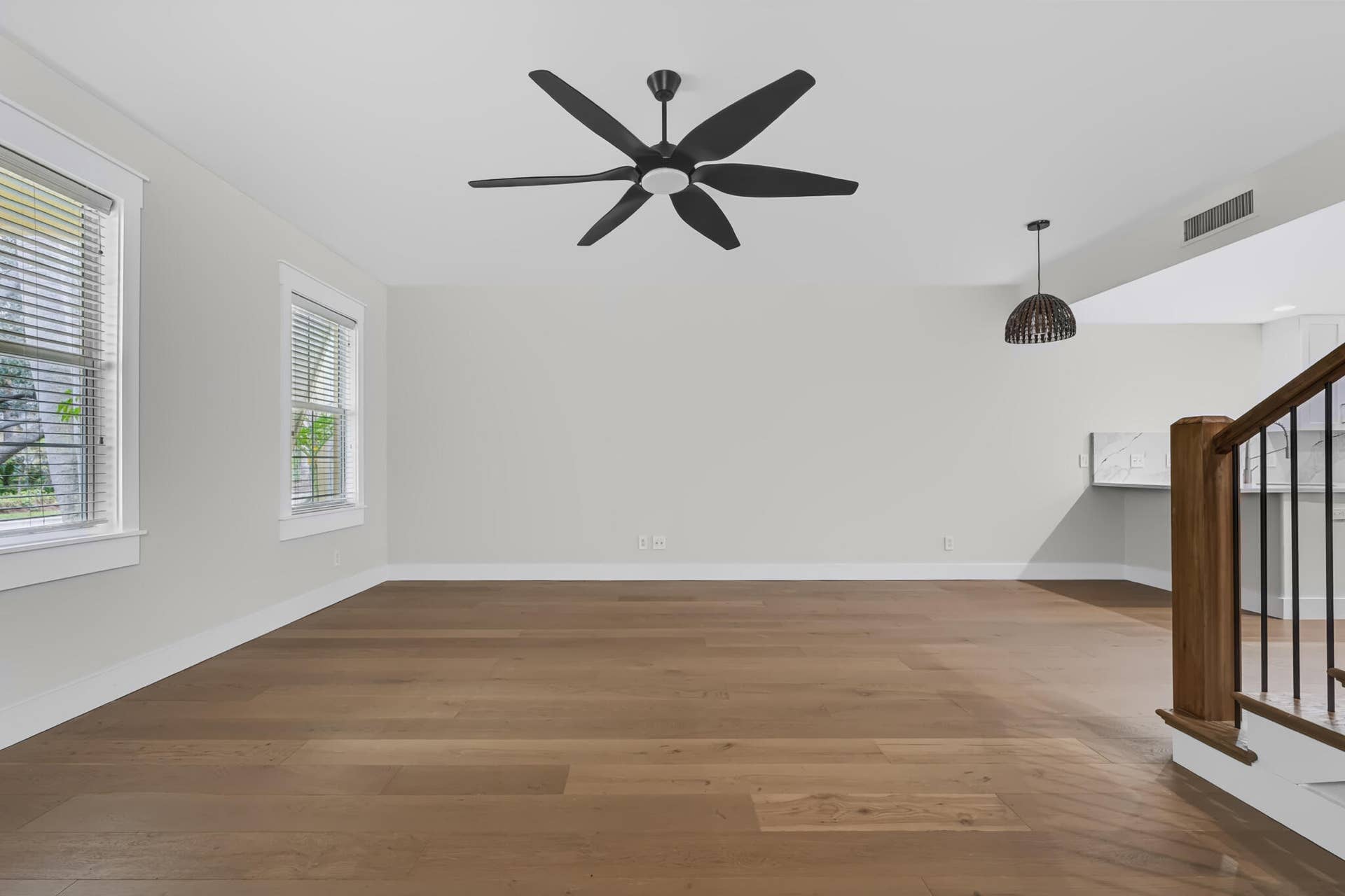 3207 E Community Drive E, Jupiter, FL 33458 Wood-finish flooring throughout, white walls, and a modern ceiling fan