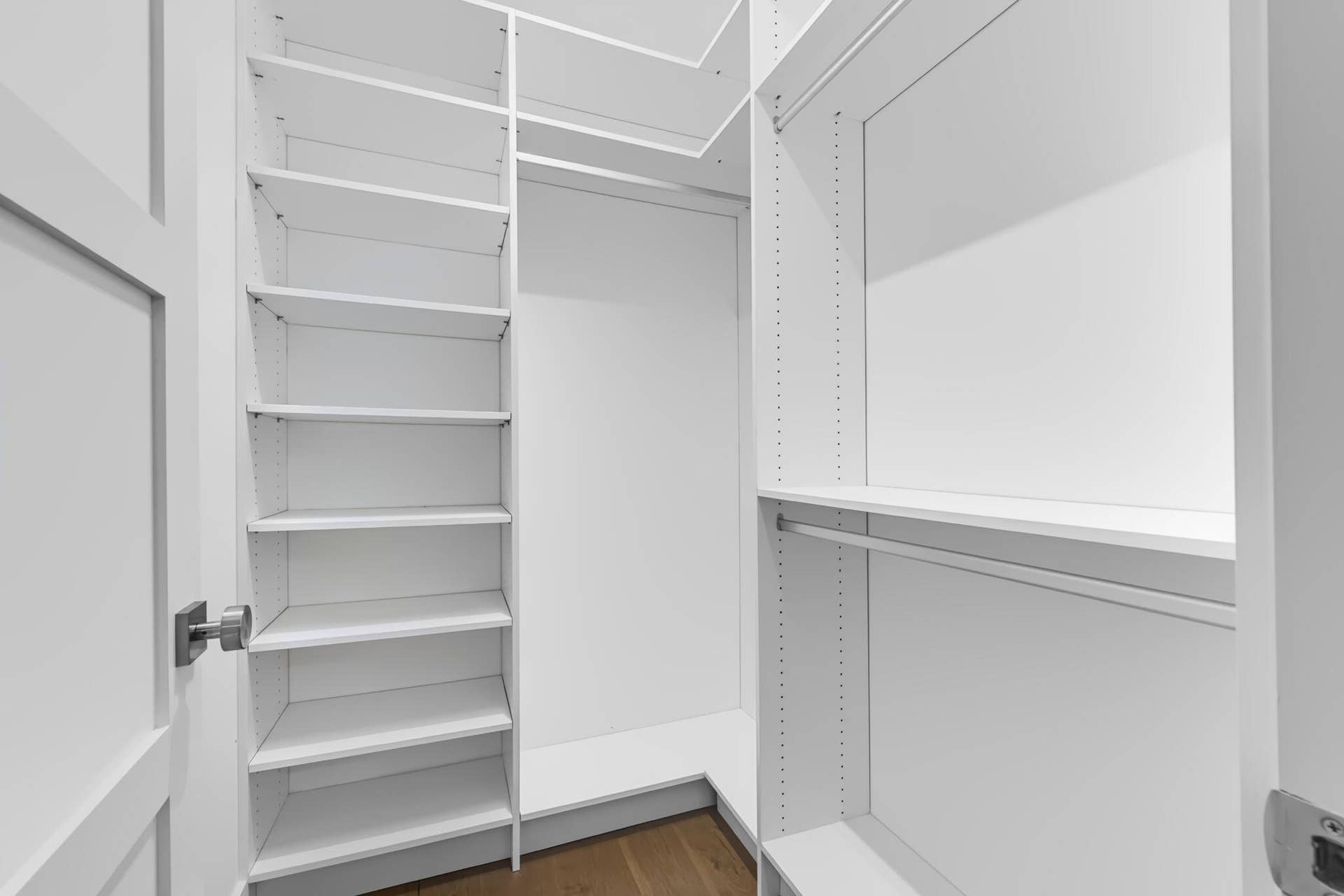 3207 E Community Drive E, Jupiter, FL 33458 Built-in closet shelving, hanging rods, and wood-finish flooring