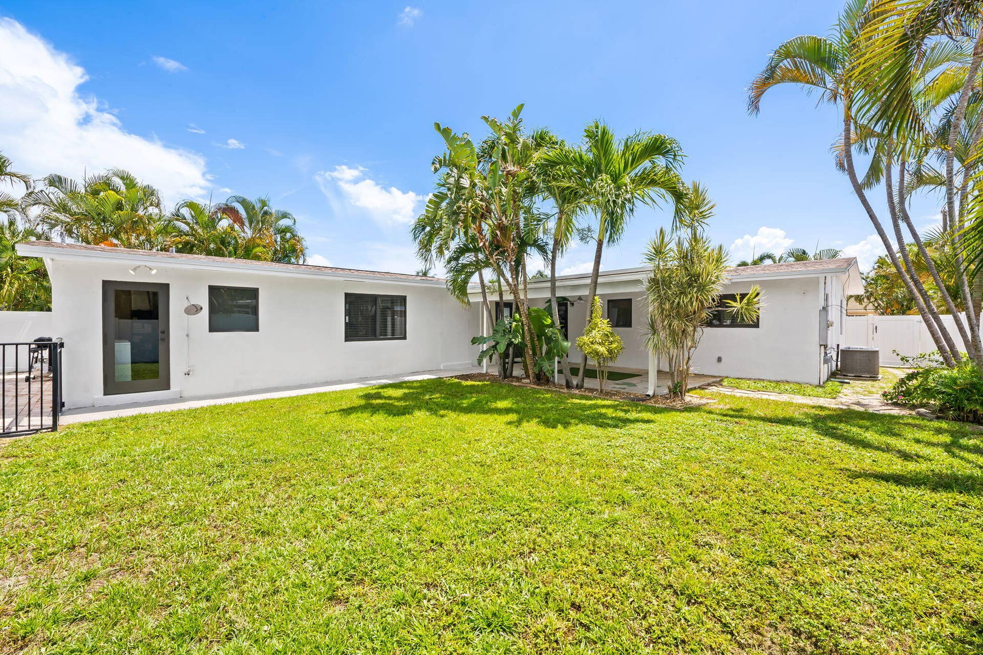 White stucco exterior with dark-framed windows