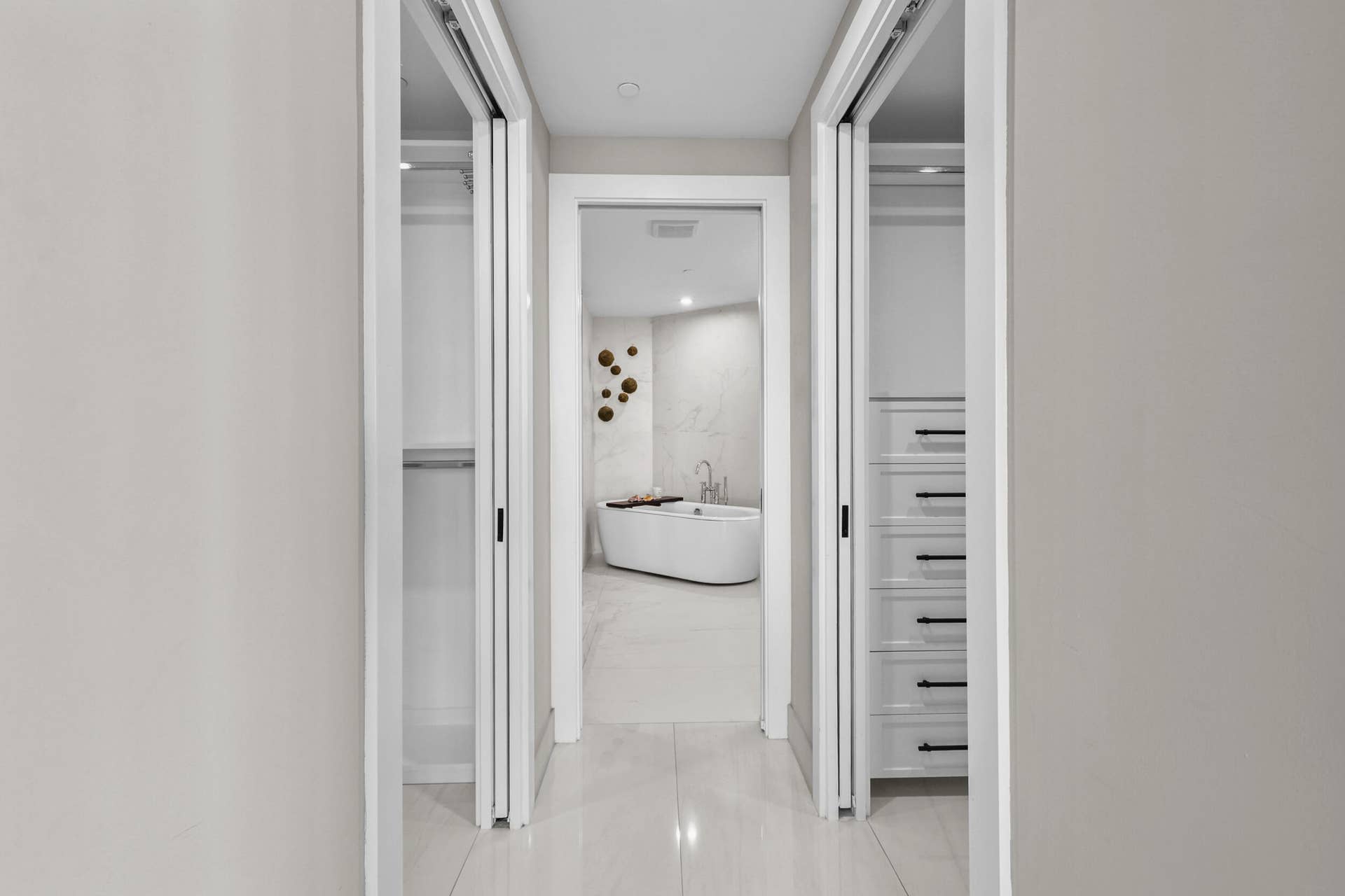 730 N Ocean Boulevard, Pompano Beach, FL 33062 Step from your bedroom past fully customized his-and-hers closets and into a serene ensuite bathroom that feels like your own private spa, complete with custom porcelain tile, a frameless glass shower, freestanding soaking tub and floating vanity with leathered quartzite countertops, all illuminated by designer sconces.