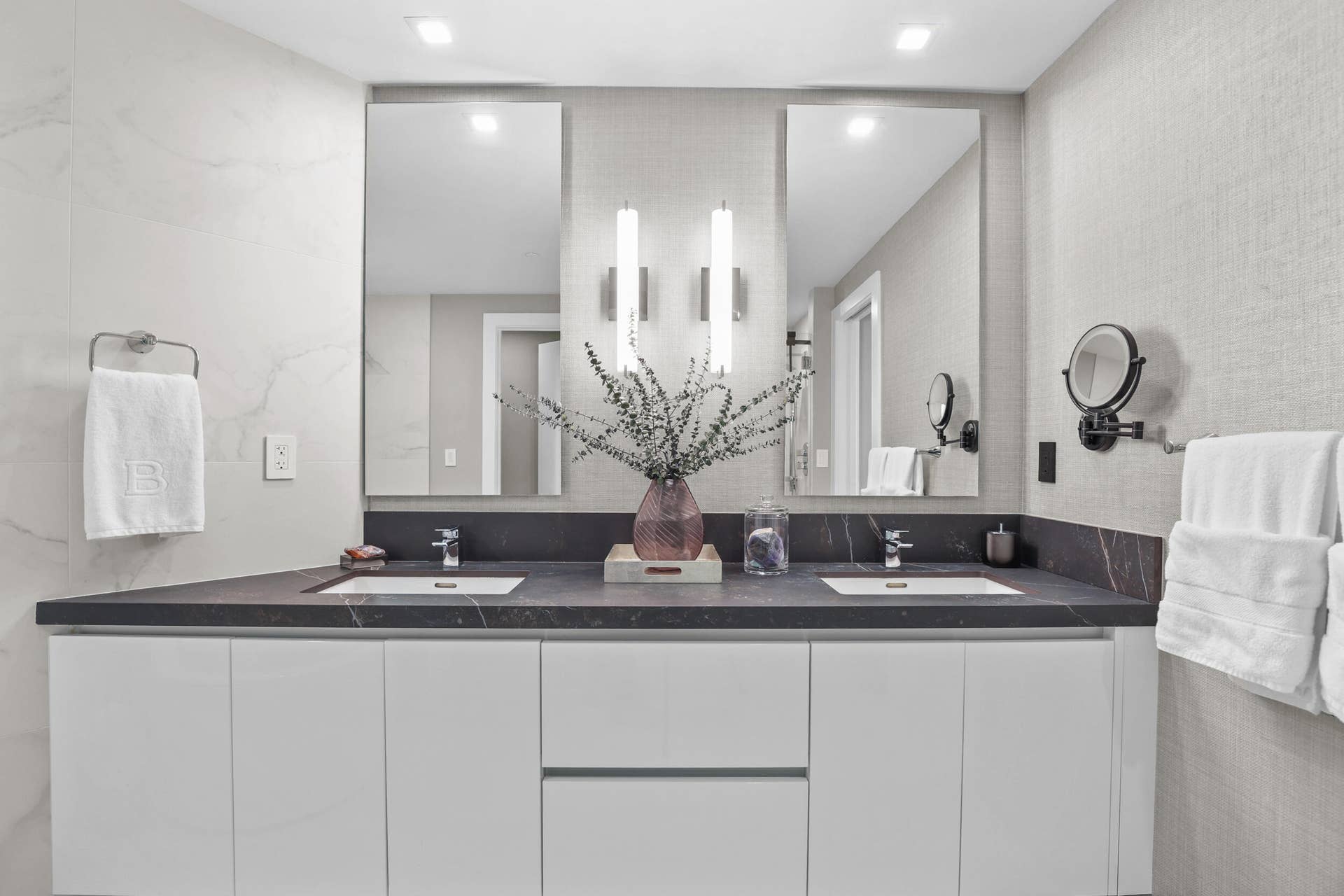 730 N Ocean Boulevard, Pompano Beach, FL 33062 A private spa within the primary suite, this exquisite bathroom showcases custom porcelain tile, a frameless glass shower, a freestanding soaking tub and a floating vanity topped with leathered quartzite, all beautifully illuminated by custom designer sconces.