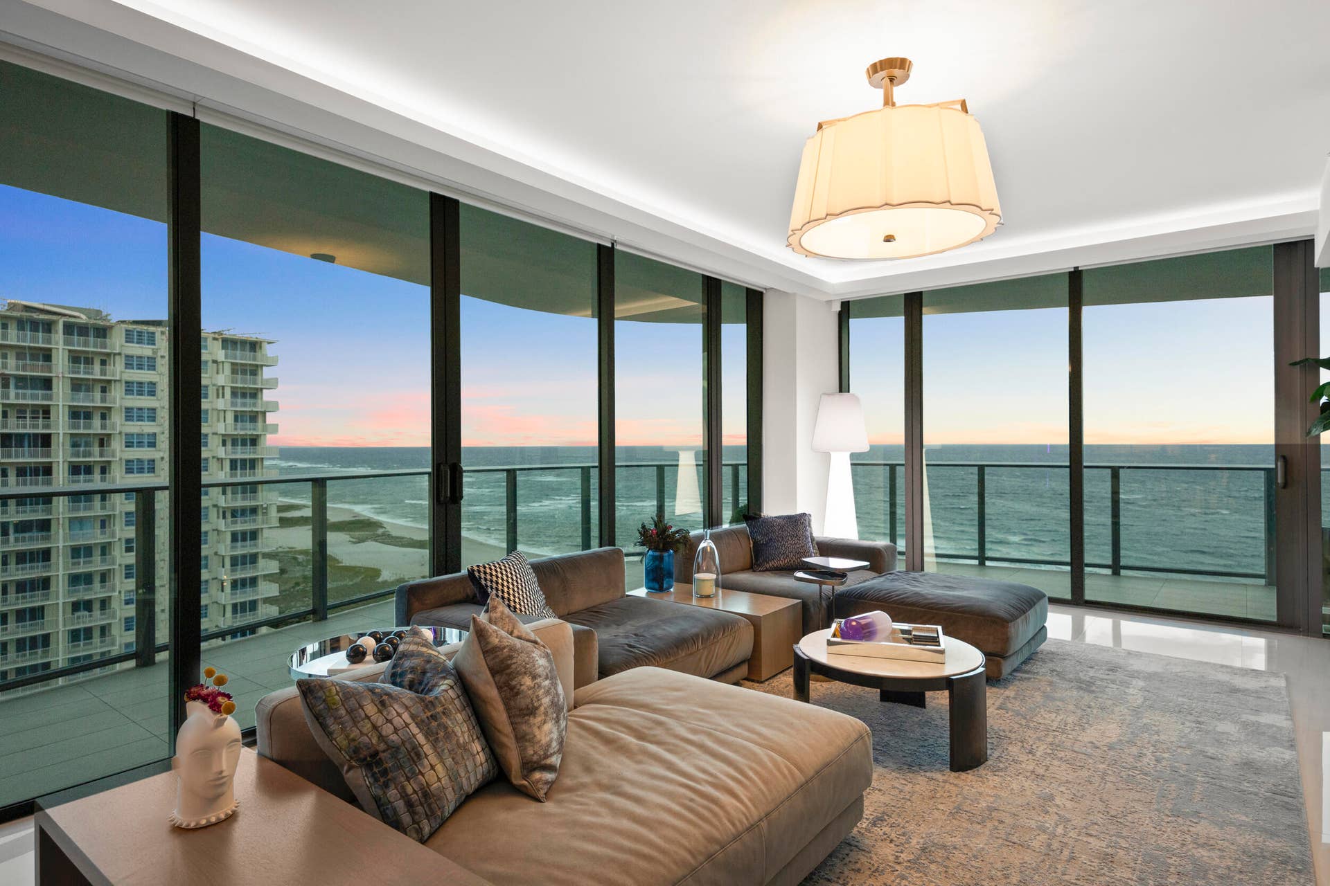 730 N Ocean Boulevard, Pompano Beach, FL 33062 As the sun sets, custom lighting and illuminated accent walls glow in harmony with the soft, colorful evening light that fills the residence.