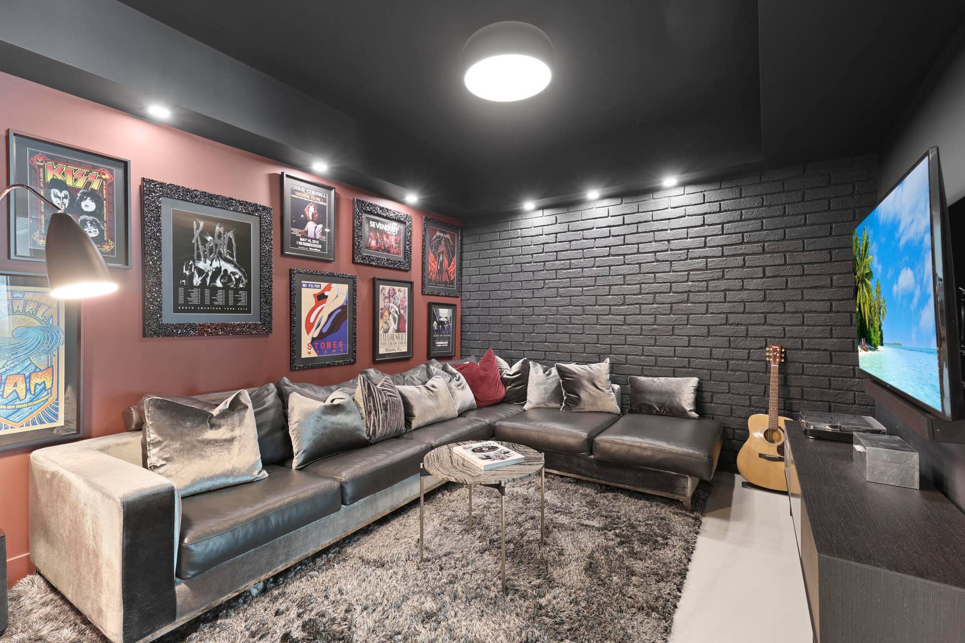 730 N Ocean Boulevard, Pompano Beach, FL 33062 A true showstopper, the den brings bold character and unexpected warmth to this oceanfront residence. A custom faux brick accent wall and dramatic lighting create an unforgettable setting for a movie theater, game room, private office or intimate lounge. Rarely found in a contemporary oceanfront home, this versatile space may also be adapted into a fourth bedroom if desired.
