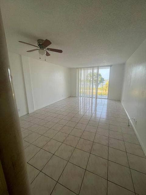 480 EXECUTIVE CENTER Drive, #2F, West Palm Beach, West Palm Beach, FL 33401 Expansive interior with tiled flooring, neutral wall tones, and a ceiling fan