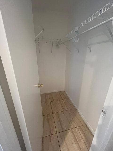 480 EXECUTIVE CENTER Drive, #2F, West Palm Beach, West Palm Beach, FL 33401 Closet featuring tile flooring, white walls, and built-in wire shelving