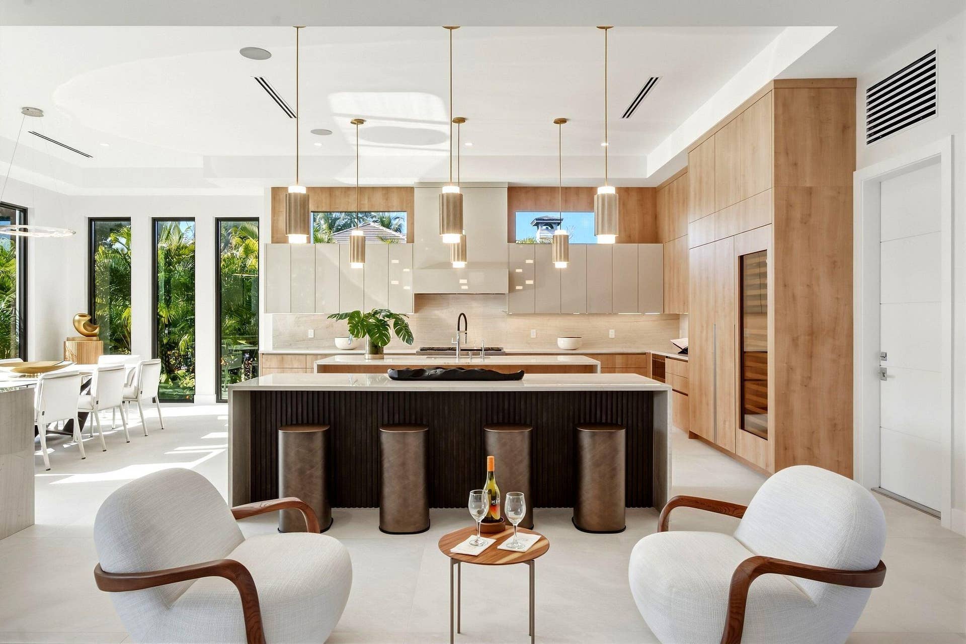Gourmet kitchen with wood-finish cabinetry, a large center island, and a built-in wine cooler