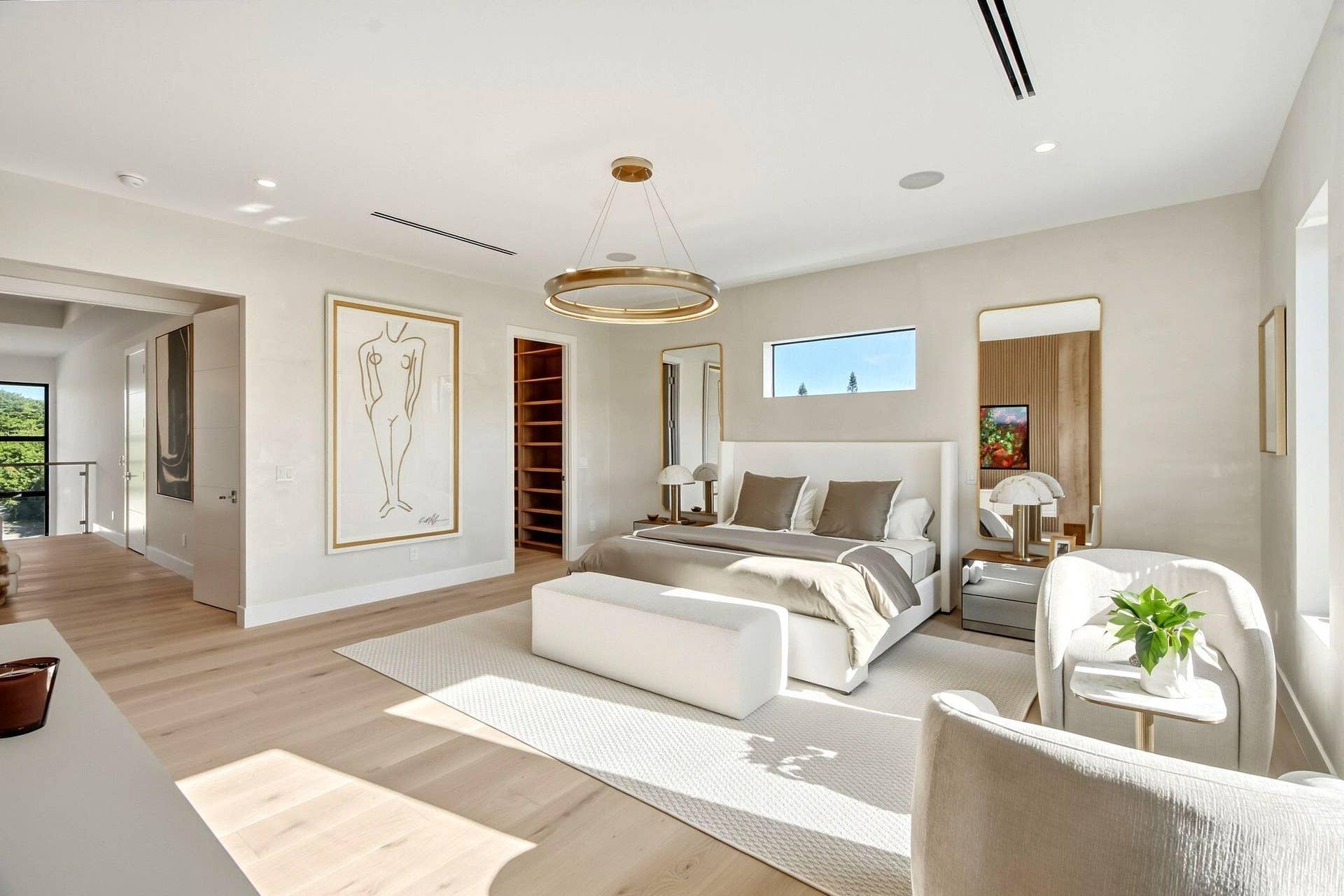 Spacious room featuring wood-finish flooring, recessed lighting, and a contemporary chandelier