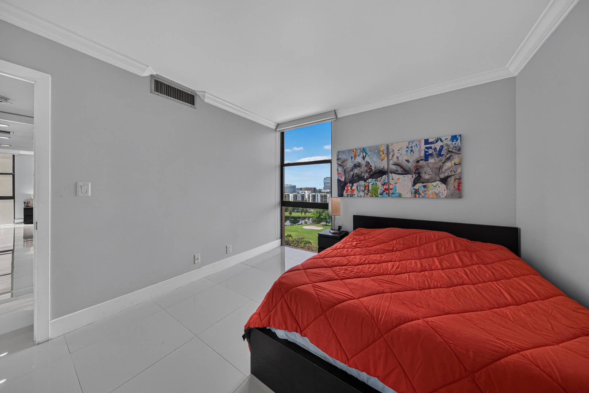 20379 W COUNTRY CLUB Drive, #1139, Aventura, FL 33180 Bright secondary bedroom showcasing tile flooring, gray painted walls, and large sliding glass doors opening to outdoor space