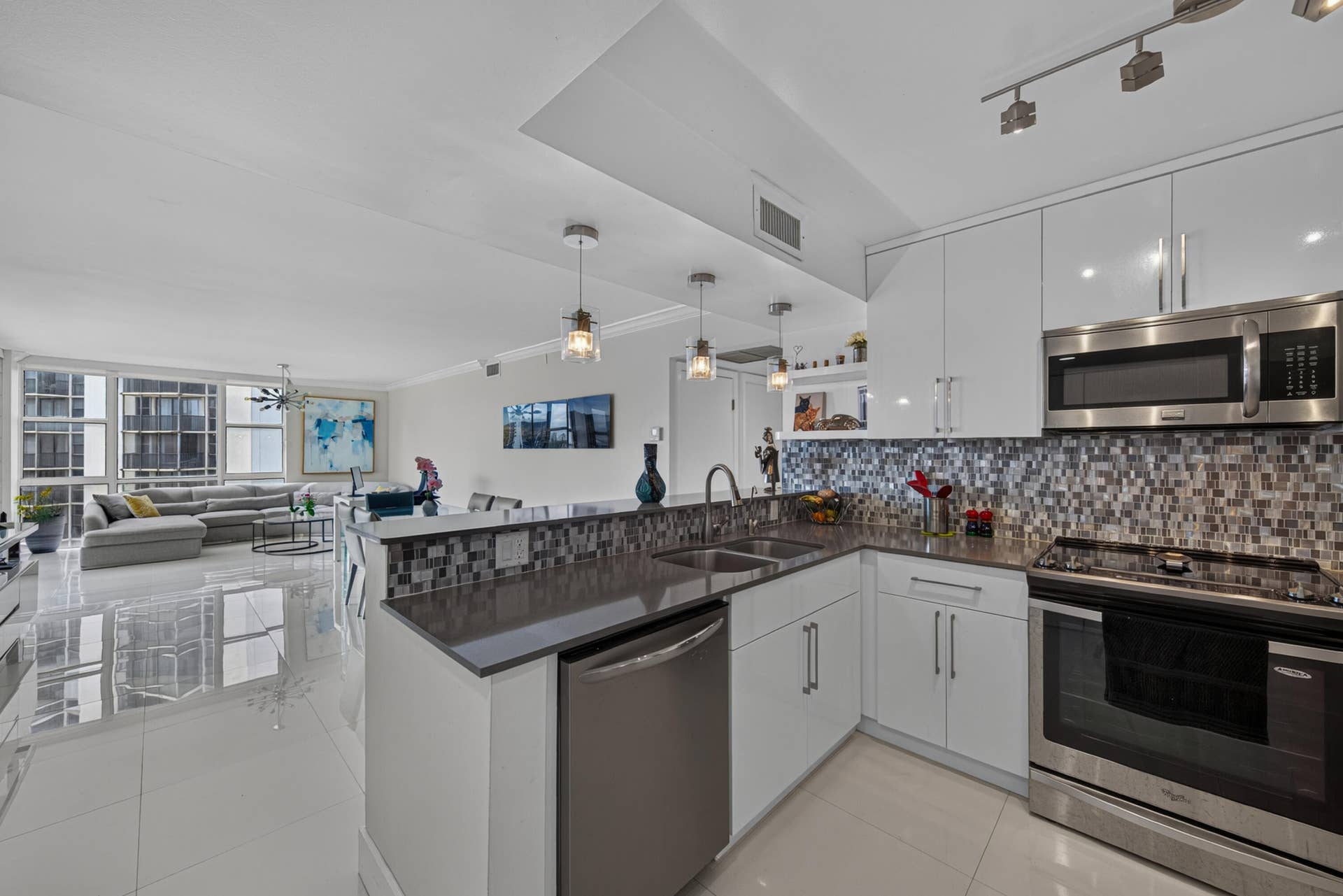 20379 W COUNTRY CLUB Drive, #1139, Aventura, FL 33180 Kitchen featuring white cabinetry, stainless steel appliances, mosaic tile backsplash, and dark countertops