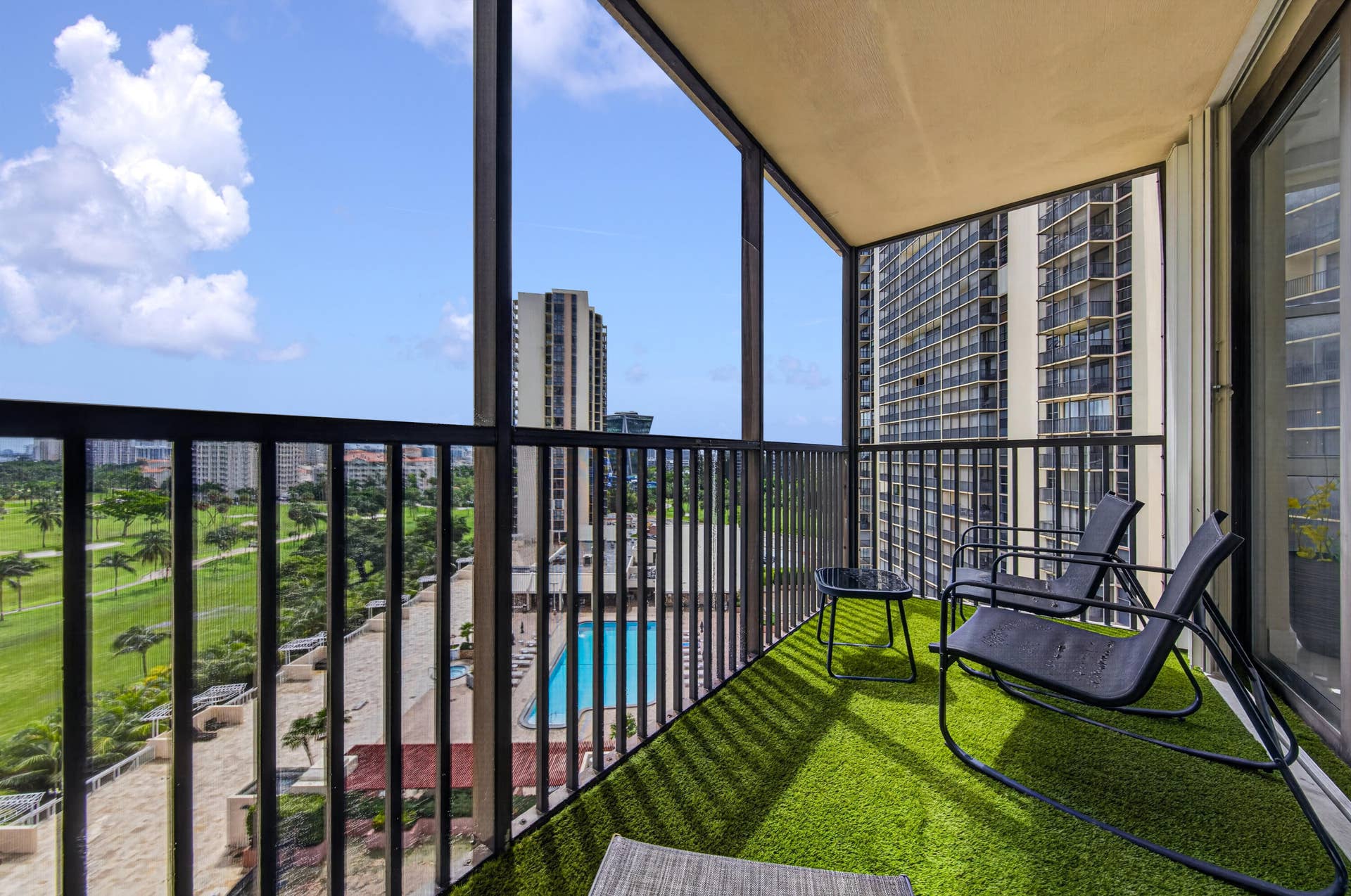 20379 W COUNTRY CLUB Drive, #1139, Aventura, FL 33180 Balcony featuring artificial turf flooring, a black metal railing, and a sliding glass door