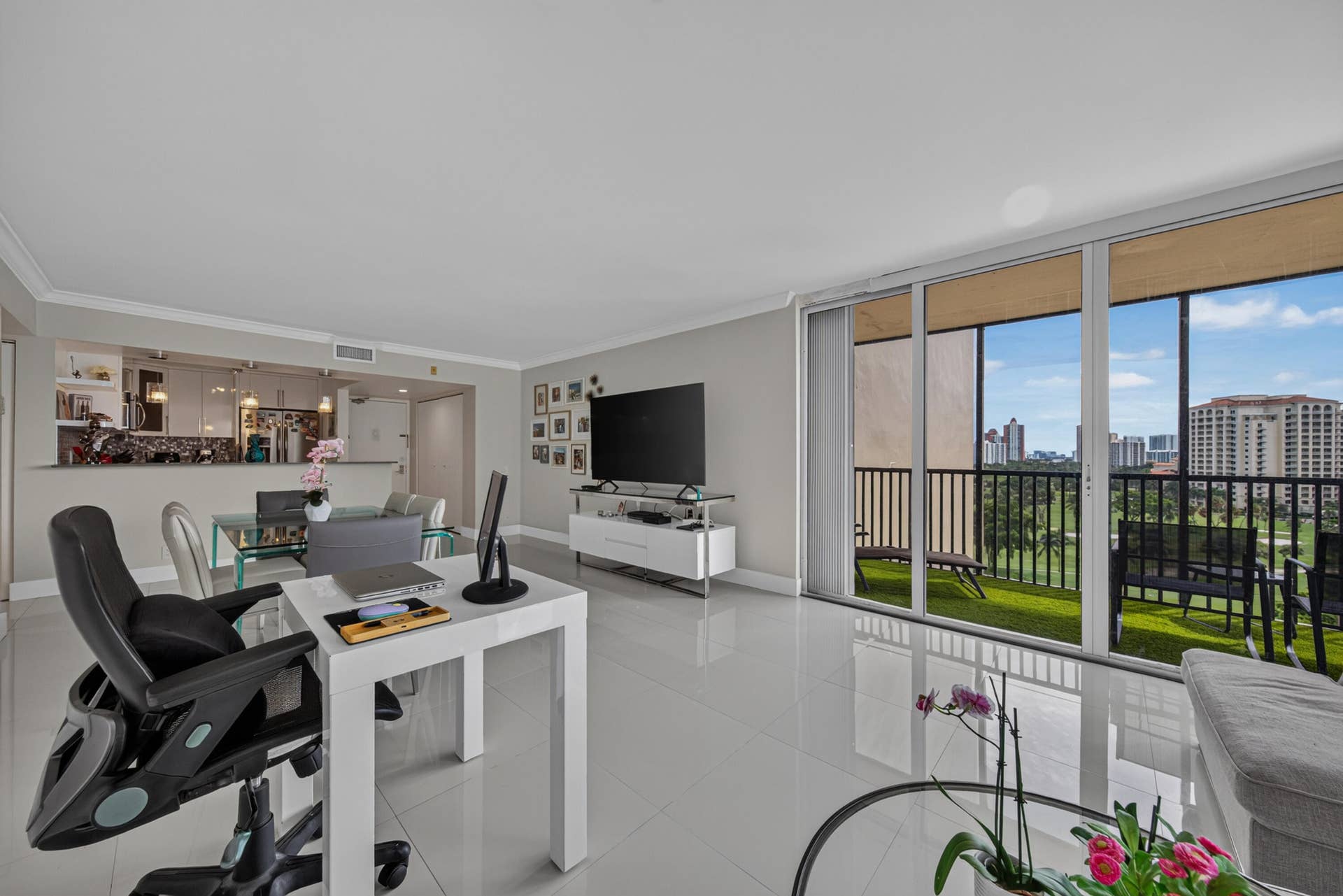 20379 W COUNTRY CLUB Drive, #1139, Aventura, FL 33180 Sliding glass doors leading to a balcony, high-gloss tile flooring, crown molding, a built-in kitchen pass-through window, and recessed lighting in the kitchen