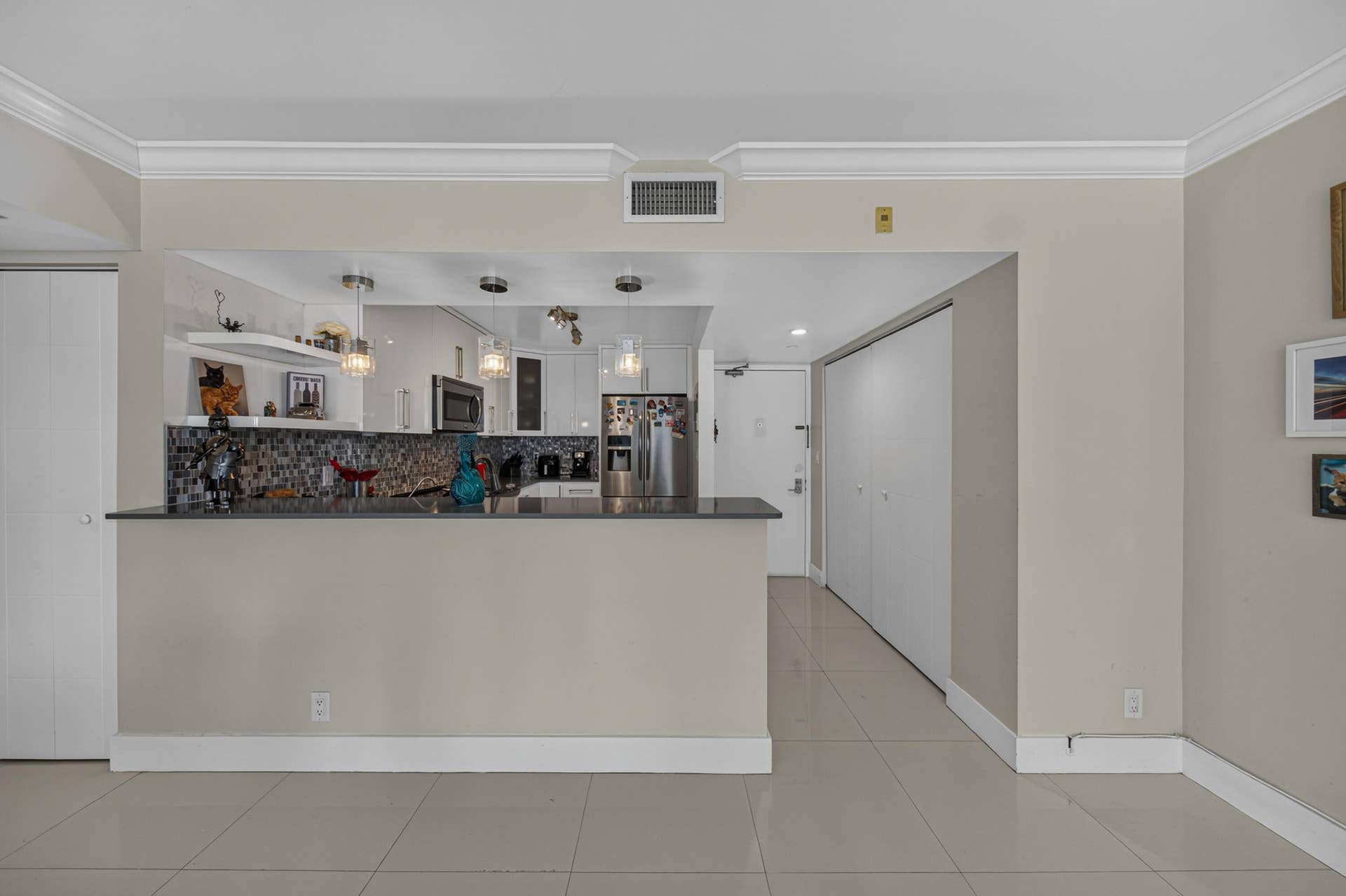 20379 W COUNTRY CLUB Drive, #1139, Aventura, FL 33180 Modern kitchen featuring white cabinetry, pendant lighting, and a dark countertop