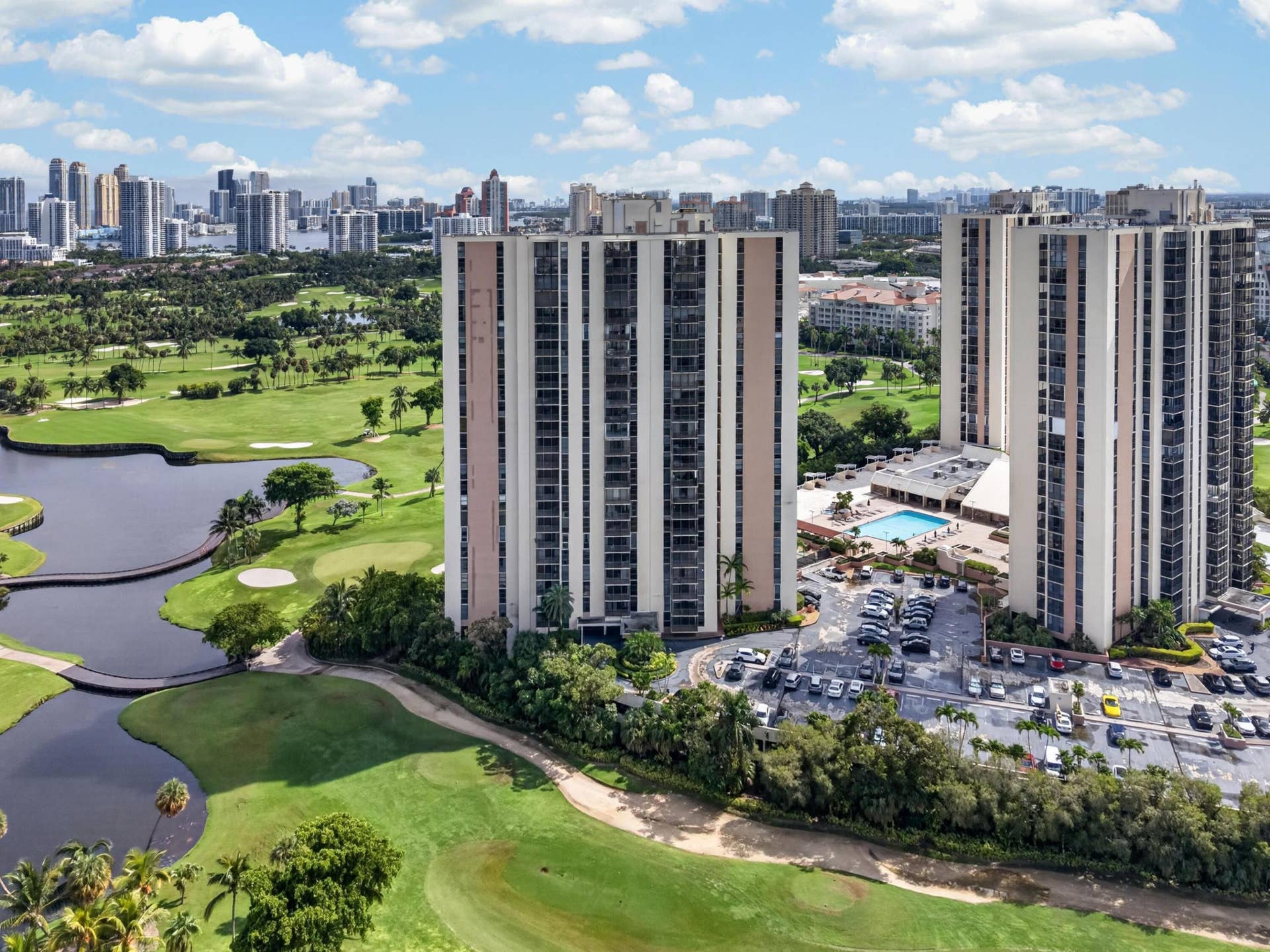 20379 W COUNTRY CLUB Drive, #1139, Aventura, FL 33180 High-rise residential buildings featuring private balconies, an outdoor swimming pool, and a surface parking area