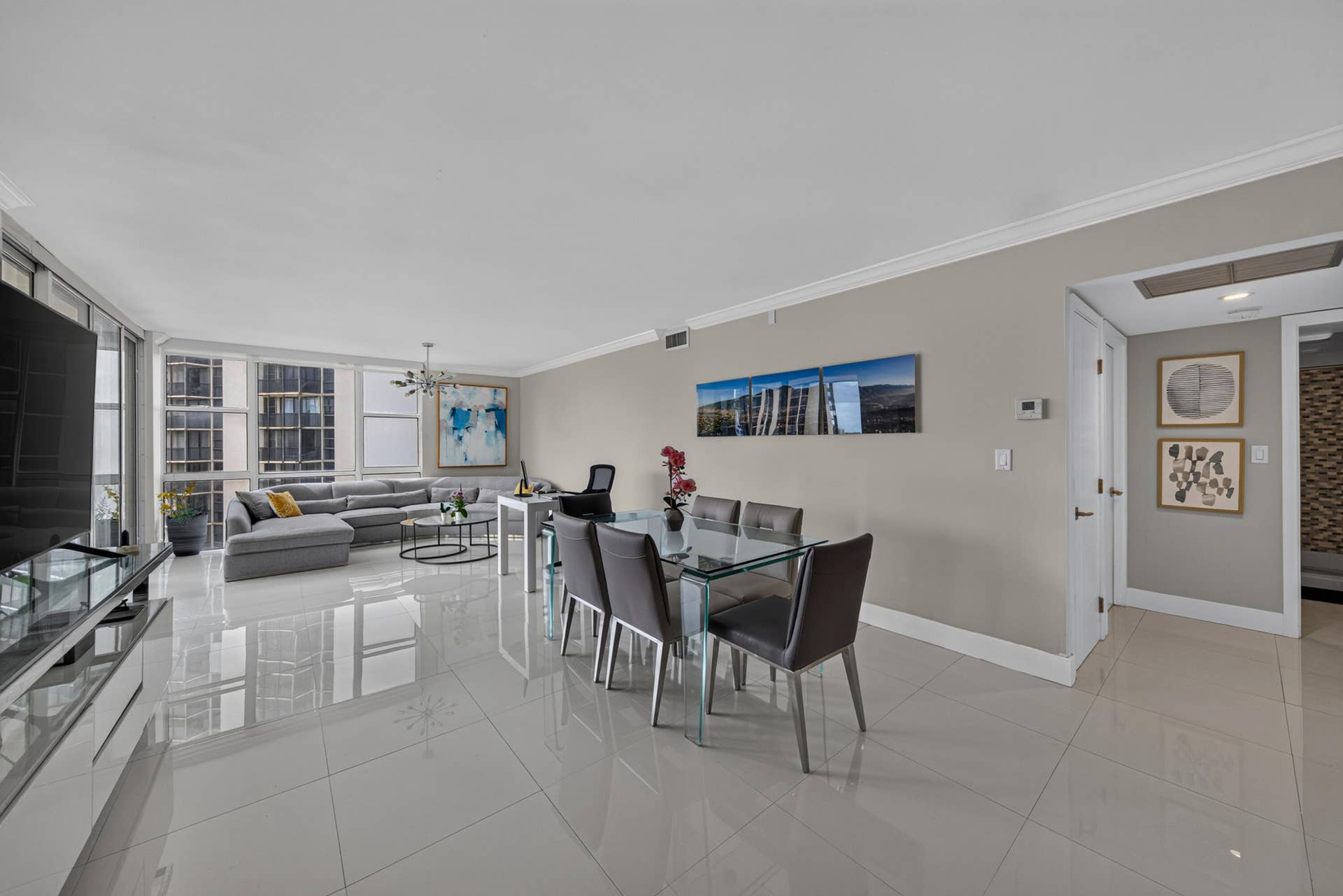 20379 W COUNTRY CLUB Drive, #1139, Aventura, FL 33180 Polished tile flooring throughout, crown molding detailing, and a modern chandelier
