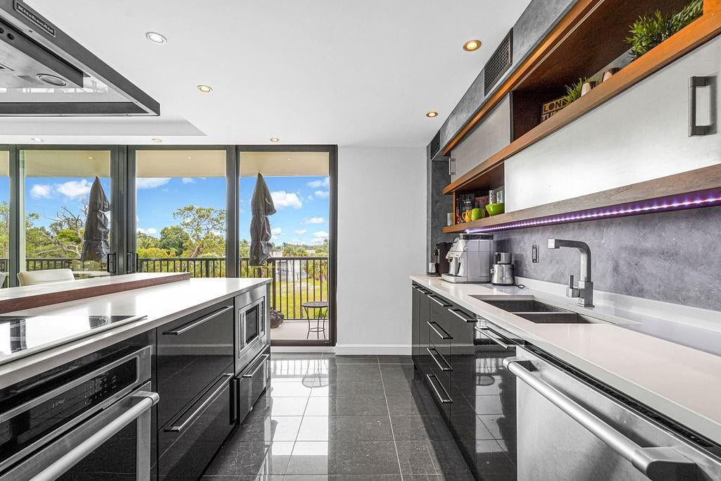 1350 River Reach Drive, #417, Fort Lauderdale, FL 33315 Striking cabinets with wood & glass accents