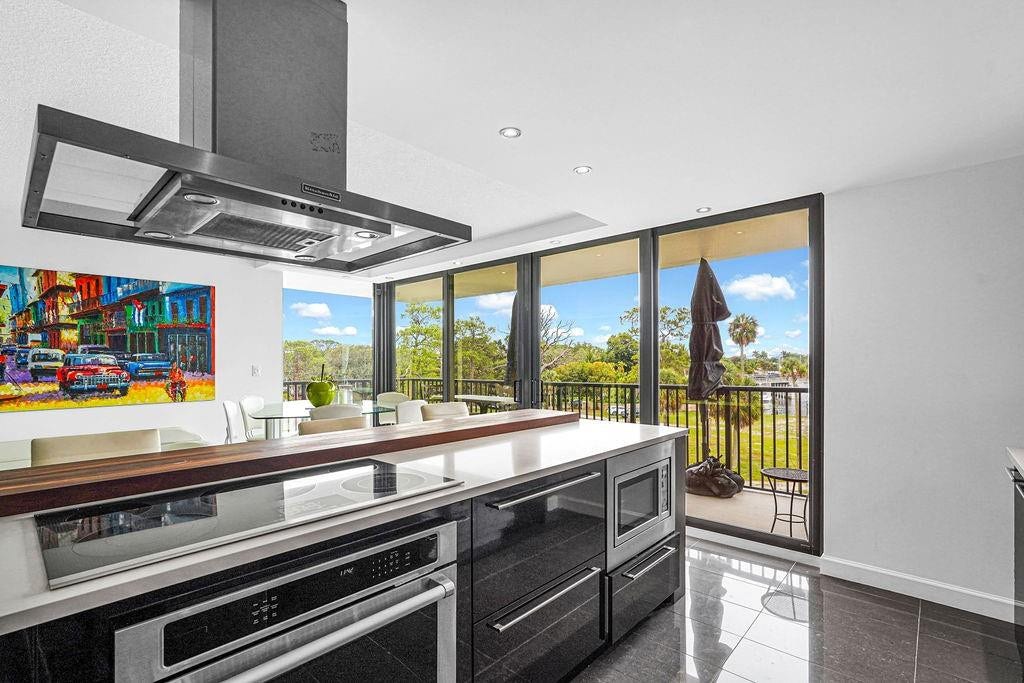 1350 River Reach Drive, #417, Fort Lauderdale, FL 33315 Kitchen with SS cooktop, undercounter oven, microwave & hood