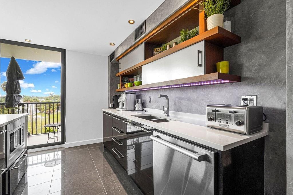 1350 River Reach Drive, #417, Fort Lauderdale, FL 33315 Sliding glass doors going out to the balcony from kitchen & living room.