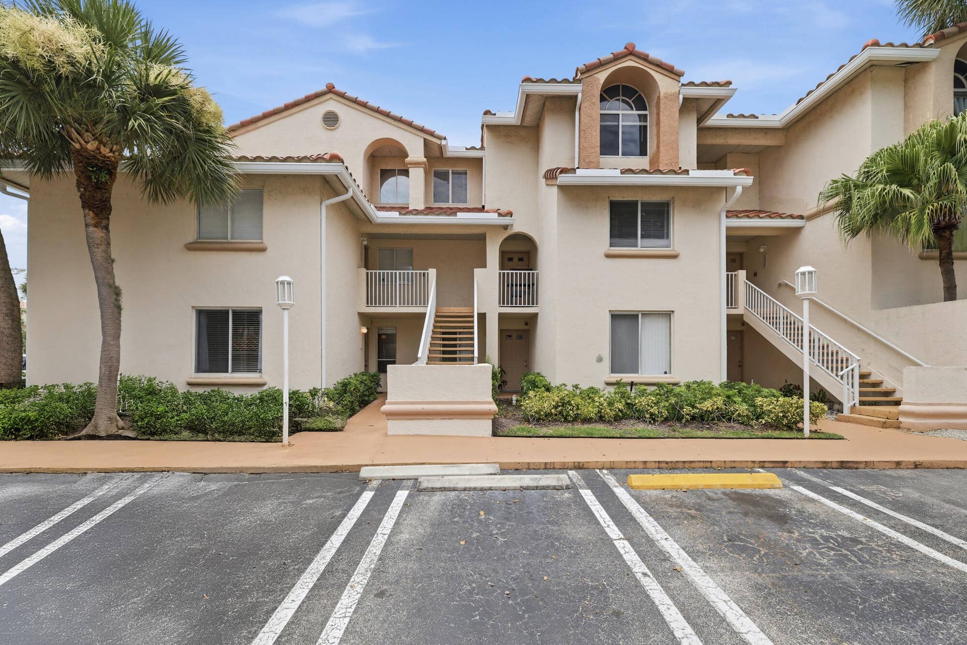 20101 Glenmoor Drive, West Palm Beach, West Palm Beach, FL 33409 Ground-floor condominium with Mediterranean-inspired architecture, a stucco exterior, and terracotta-style roof tiles.