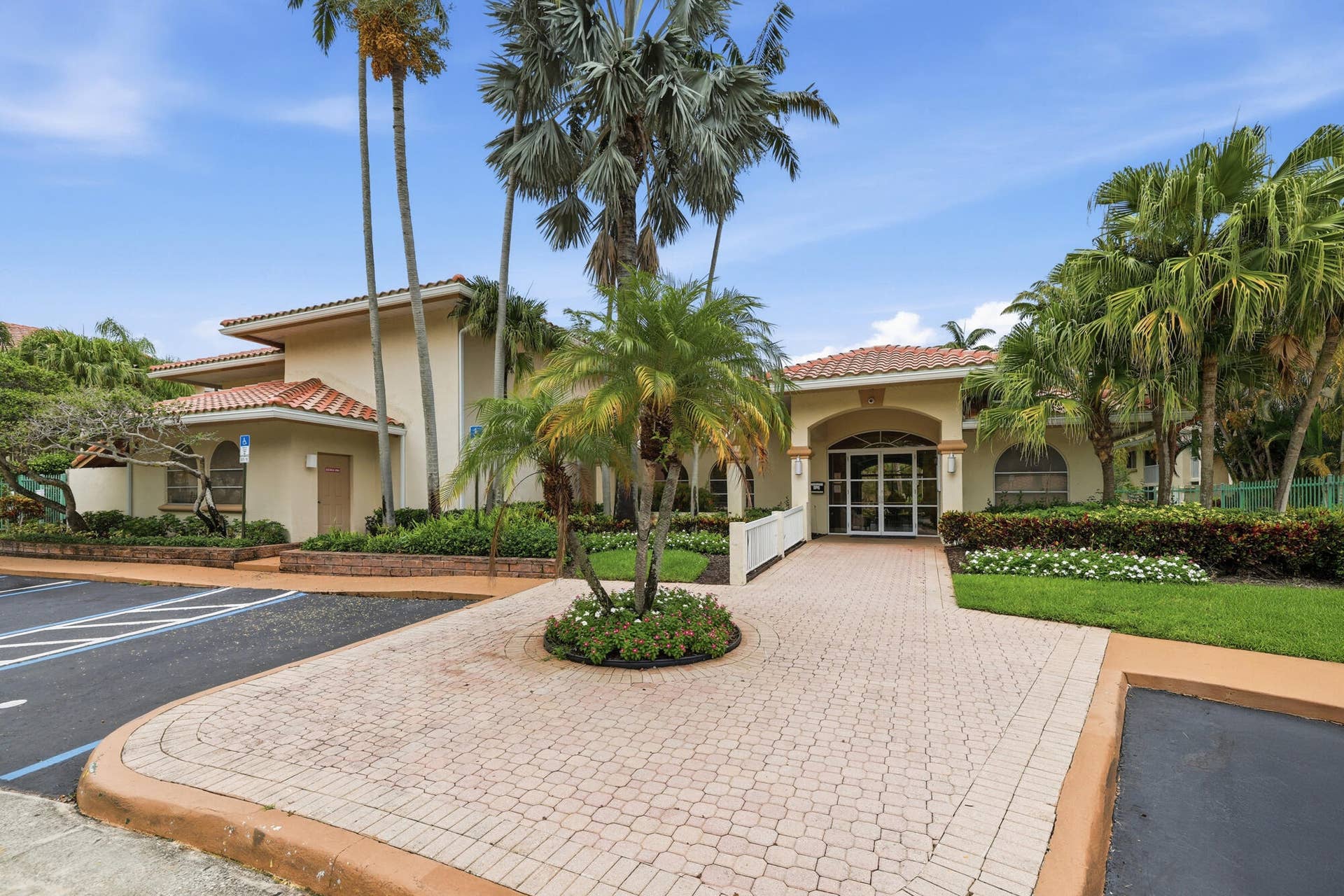 20101 Glenmoor Drive, West Palm Beach, West Palm Beach, FL 33409 Mediterranean-style building with a terracotta tile roof and stucco exterior