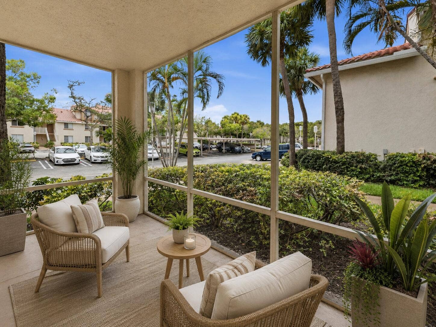 20101 Glenmoor Drive, West Palm Beach, West Palm Beach, FL 33409 Screened patio featuring a concrete floor, lush tropical landscaping, and mature palm trees