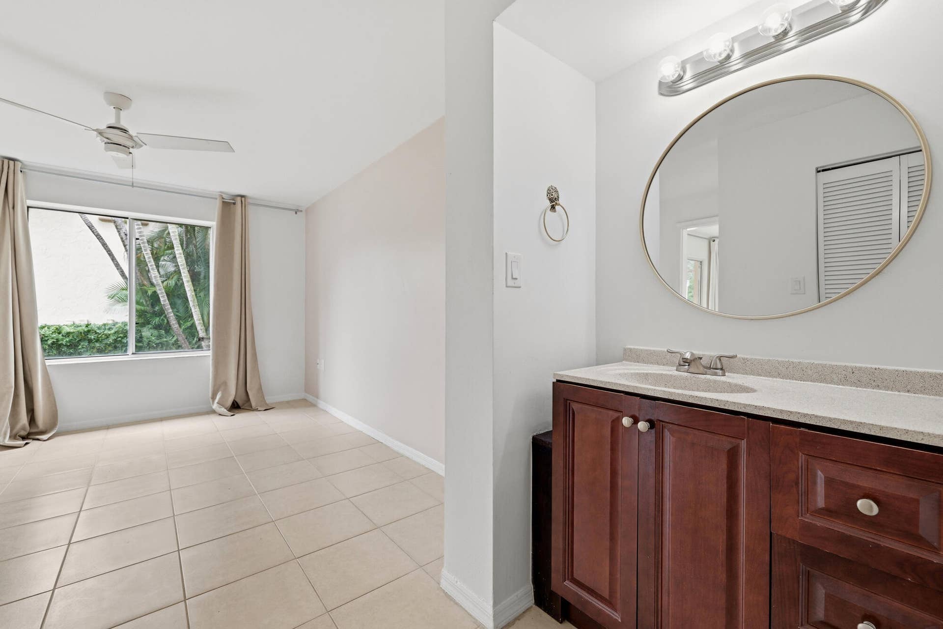 20101 Glenmoor Drive, West Palm Beach, West Palm Beach, FL 33409 Bathroom vanity featuring a light-toned countertop, undermount sink, and dark wood-finish cabinetry