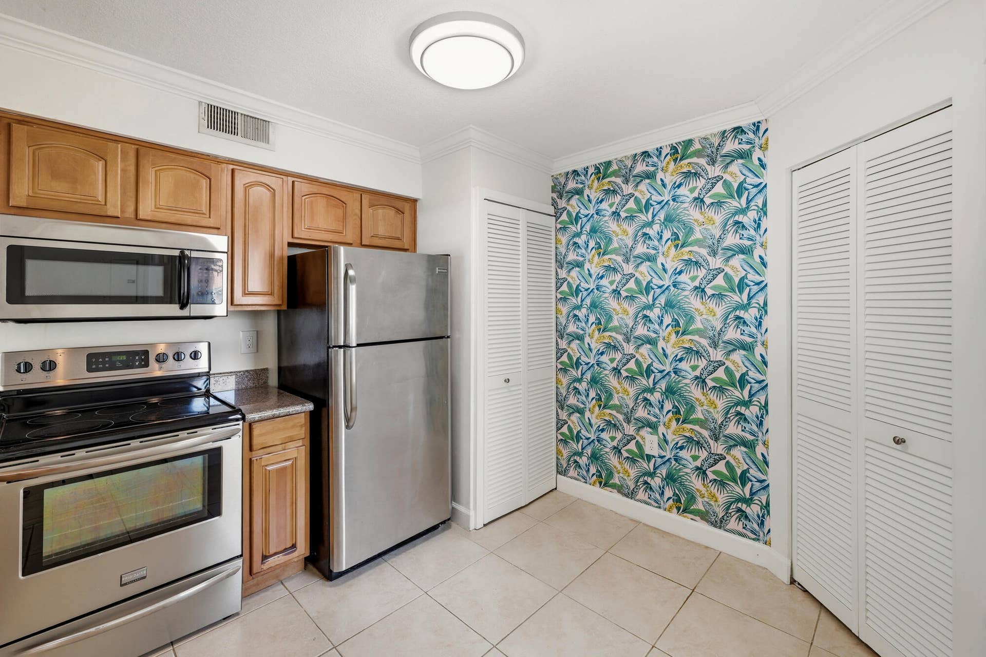 20101 Glenmoor Drive, West Palm Beach, West Palm Beach, FL 33409 Kitchen featuring stainless steel appliances, wood cabinetry, stone countertops, and tile flooring