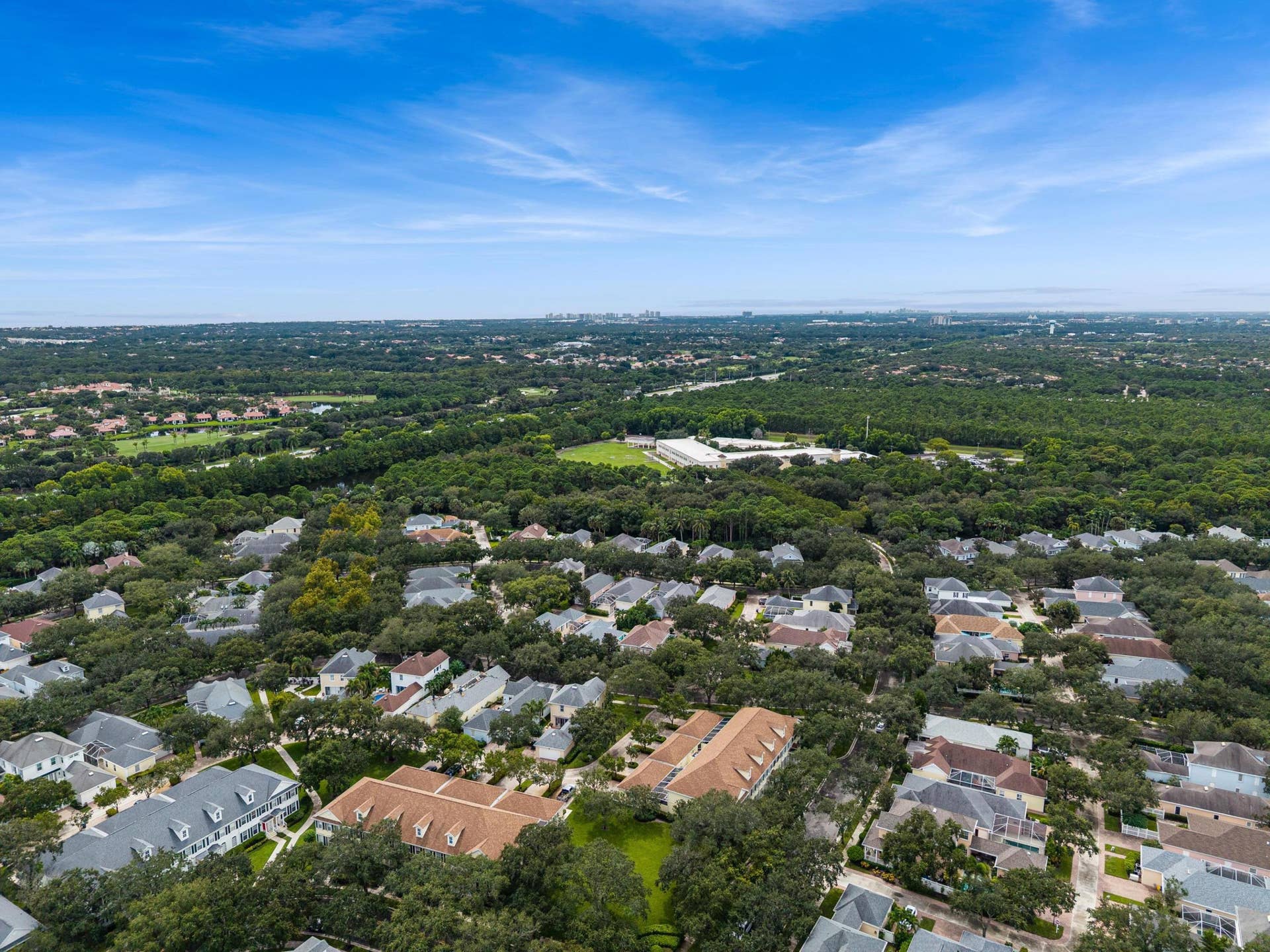 254 Marlberry Circle, Jupiter, FL 33458 Aerial of the neighborhood's mature tree canopy, with preserve land beyond