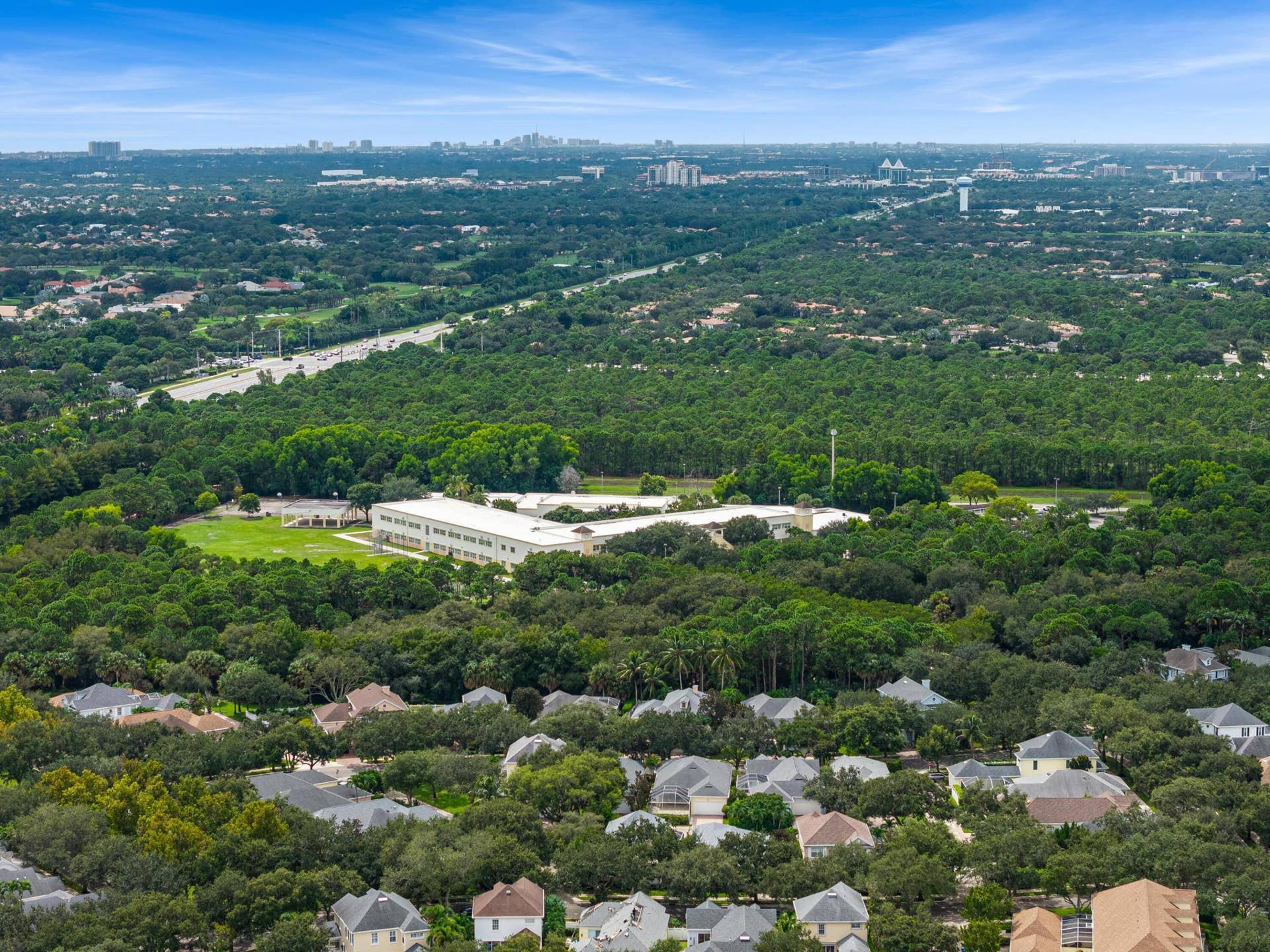 254 Marlberry Circle, Jupiter, FL 33458 Aerial over mature oaks and preserve land toward the distant skyline