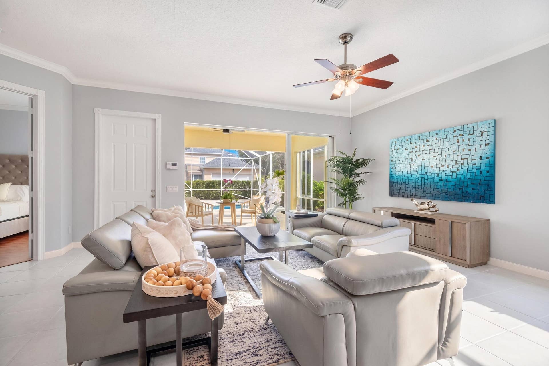 254 Marlberry Circle, Jupiter, FL 33458 Living room with sliders to the screened patio and direct access to the primary bedroom